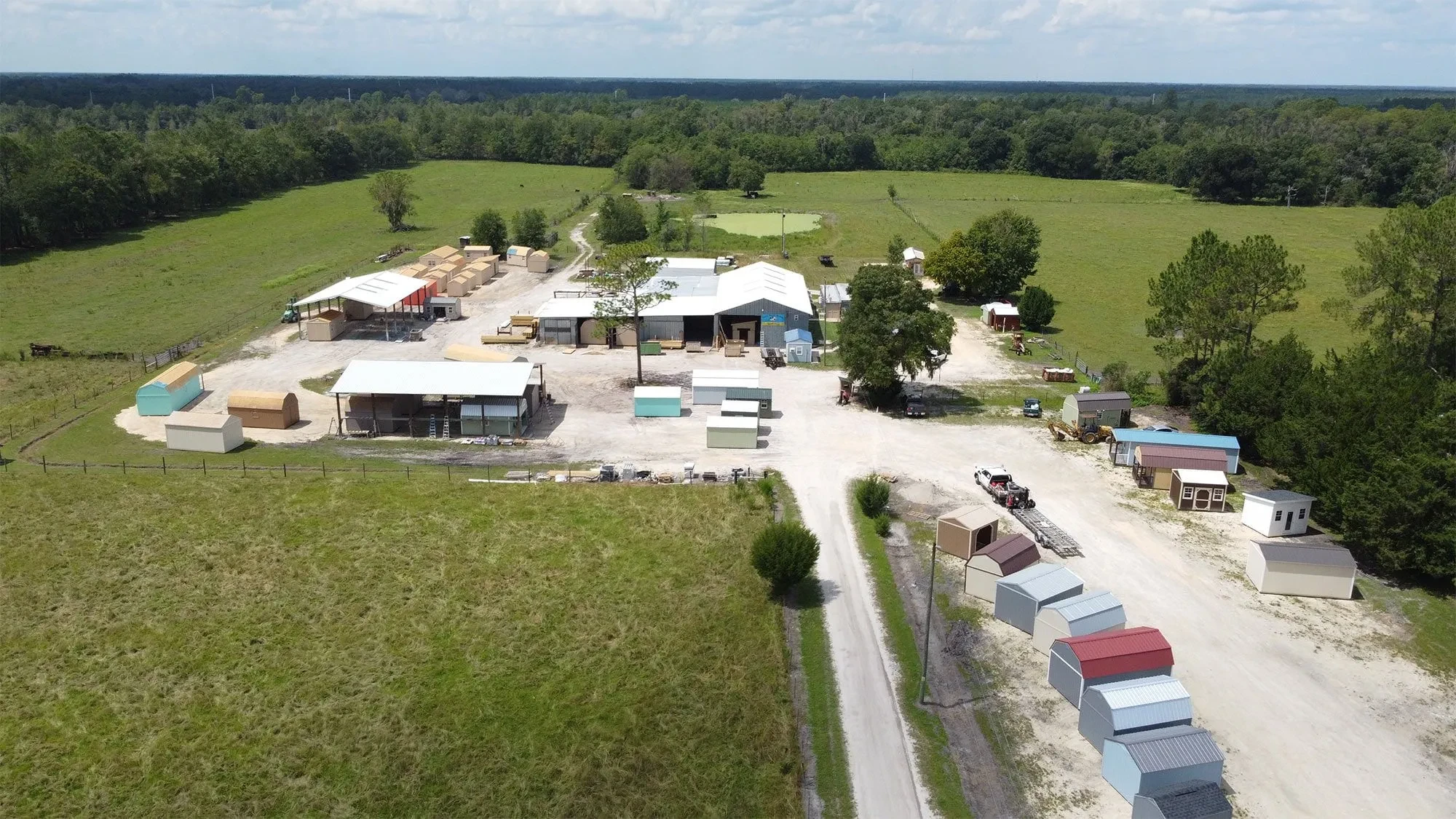 Arial view of a shed manufacturing lot in Florida during the summer. You can see shops, offices, and many colorful sheds.