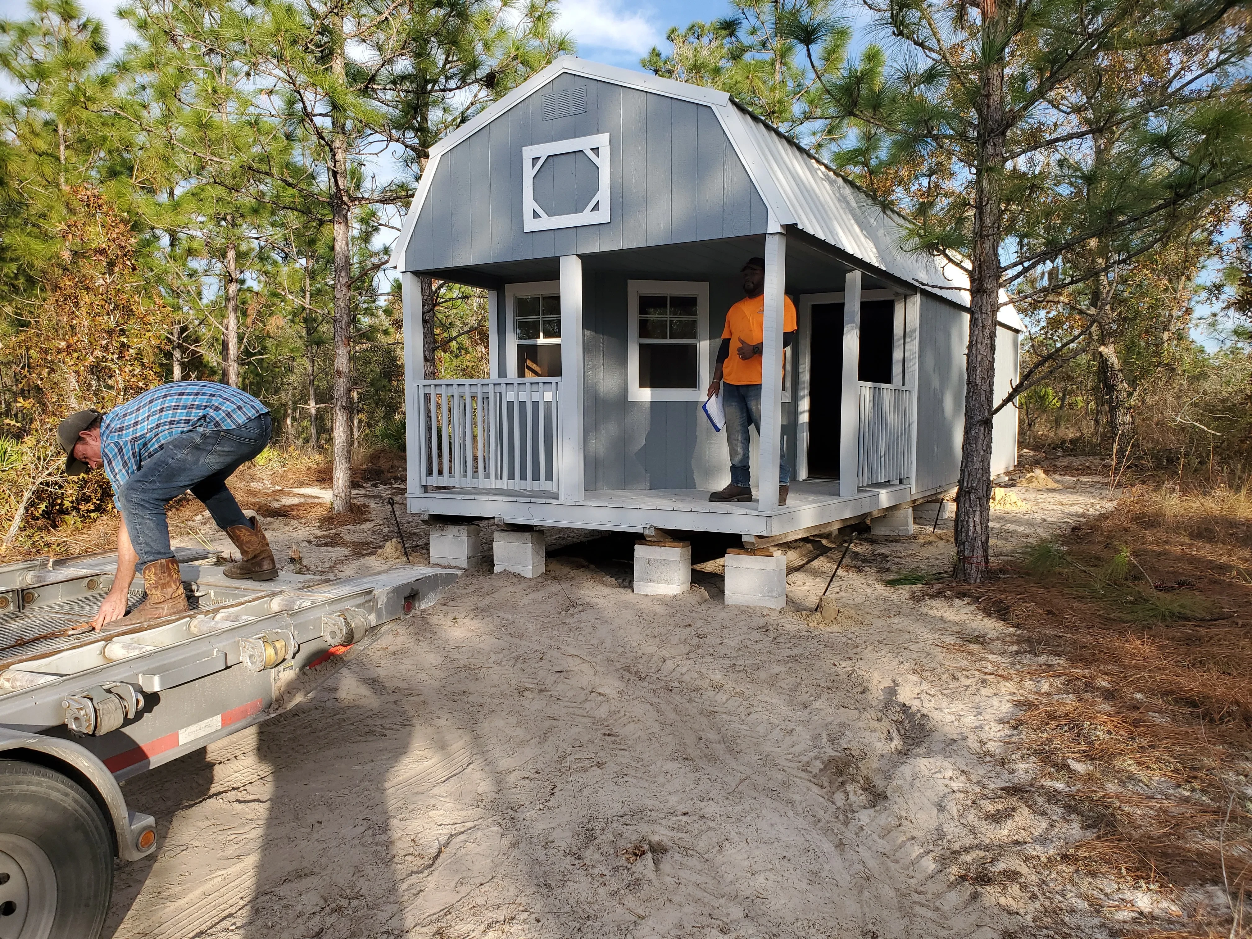 Blue lofted barn cabin set up on blocks