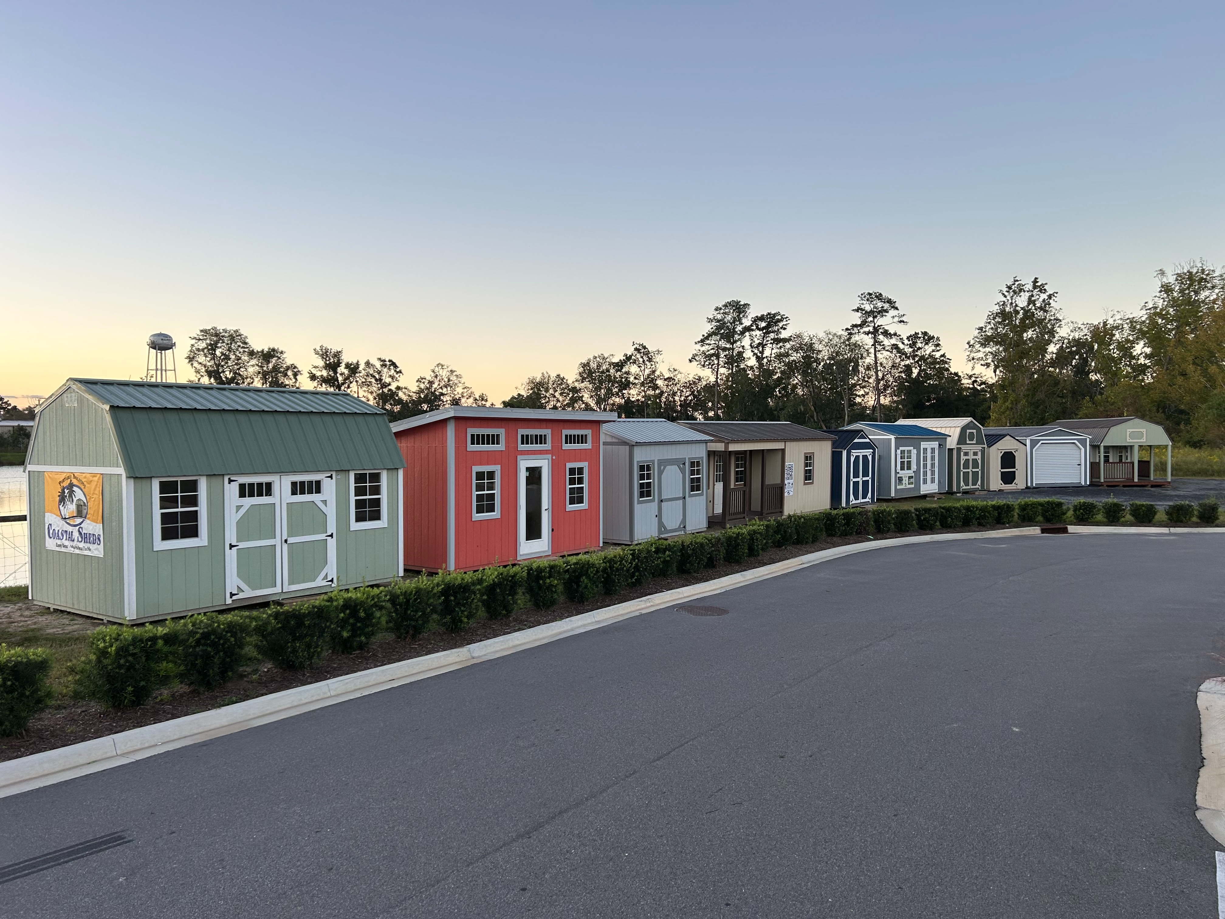 Row of classic line wood sheds showing styles and colors