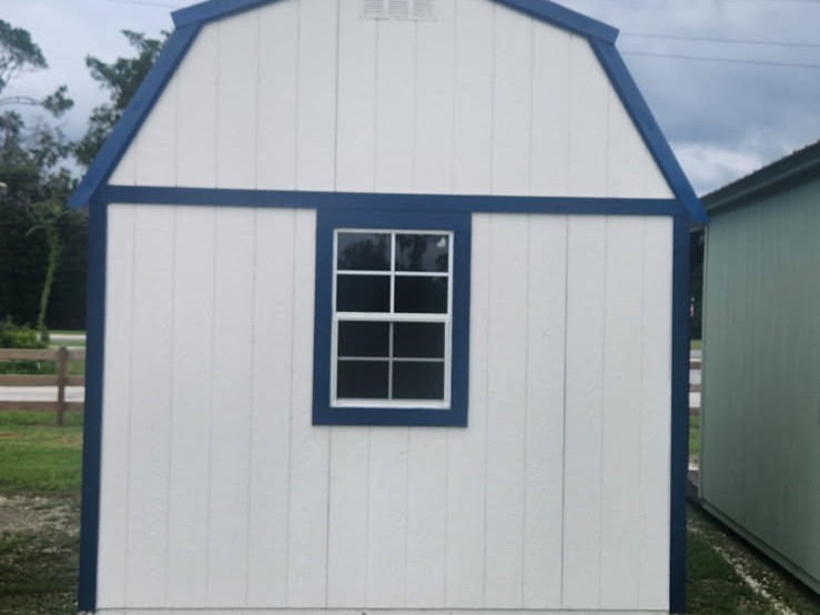 Exterior of a white 10x16 lofted barn back wall with a window