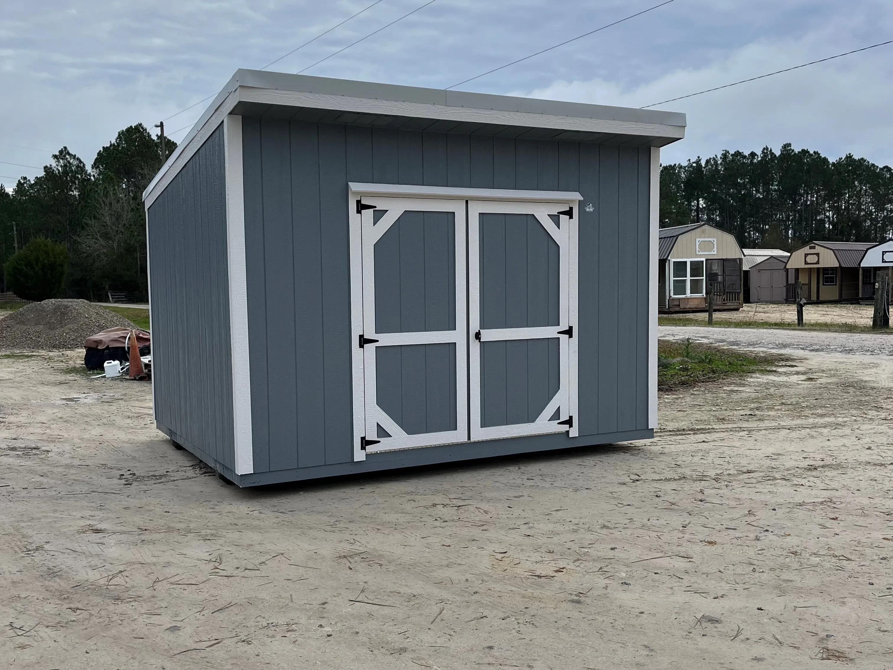 Exterior of a 10x12 dark grey urban with double wood doors