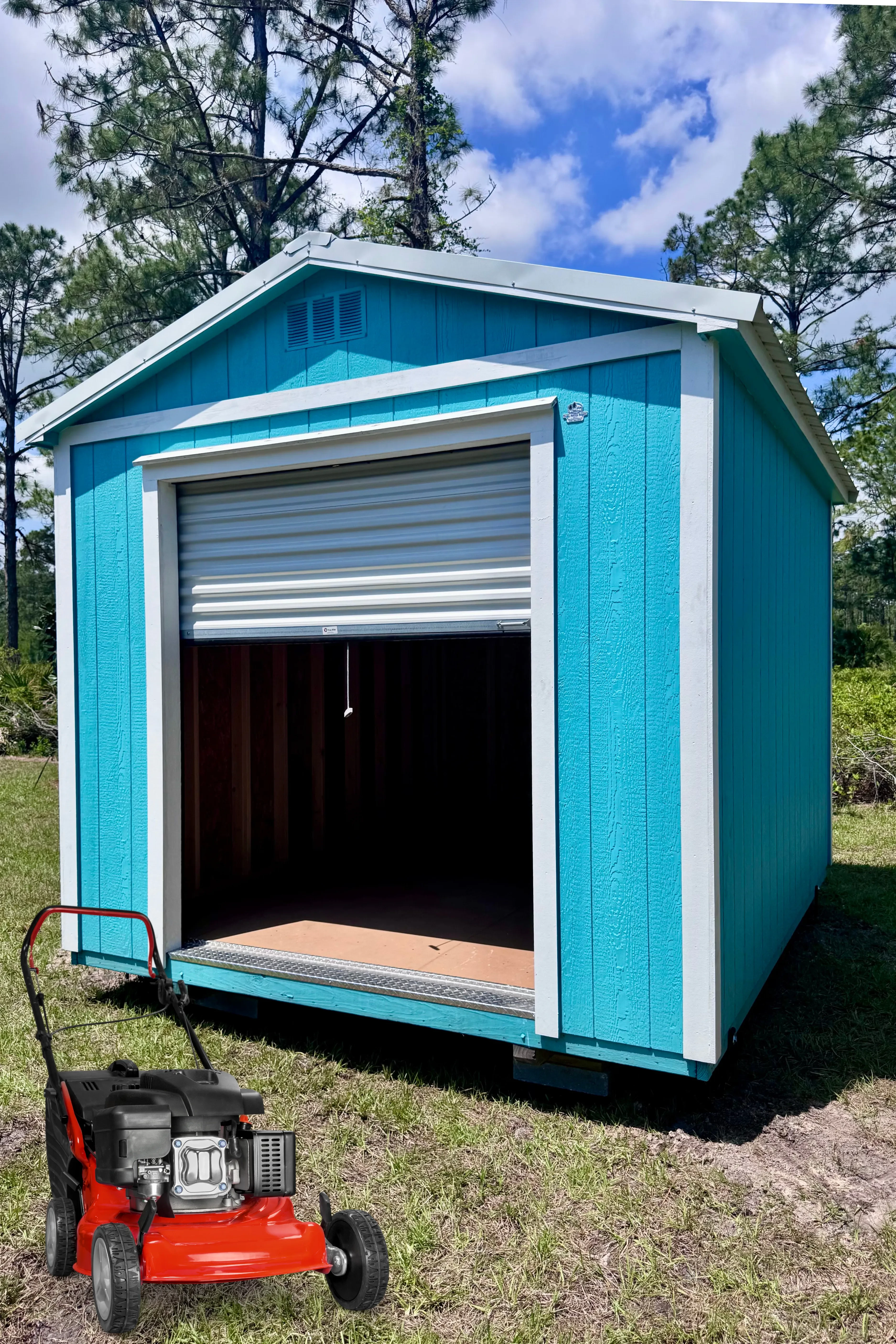 Bright blue garage shed with rollup door for driving in