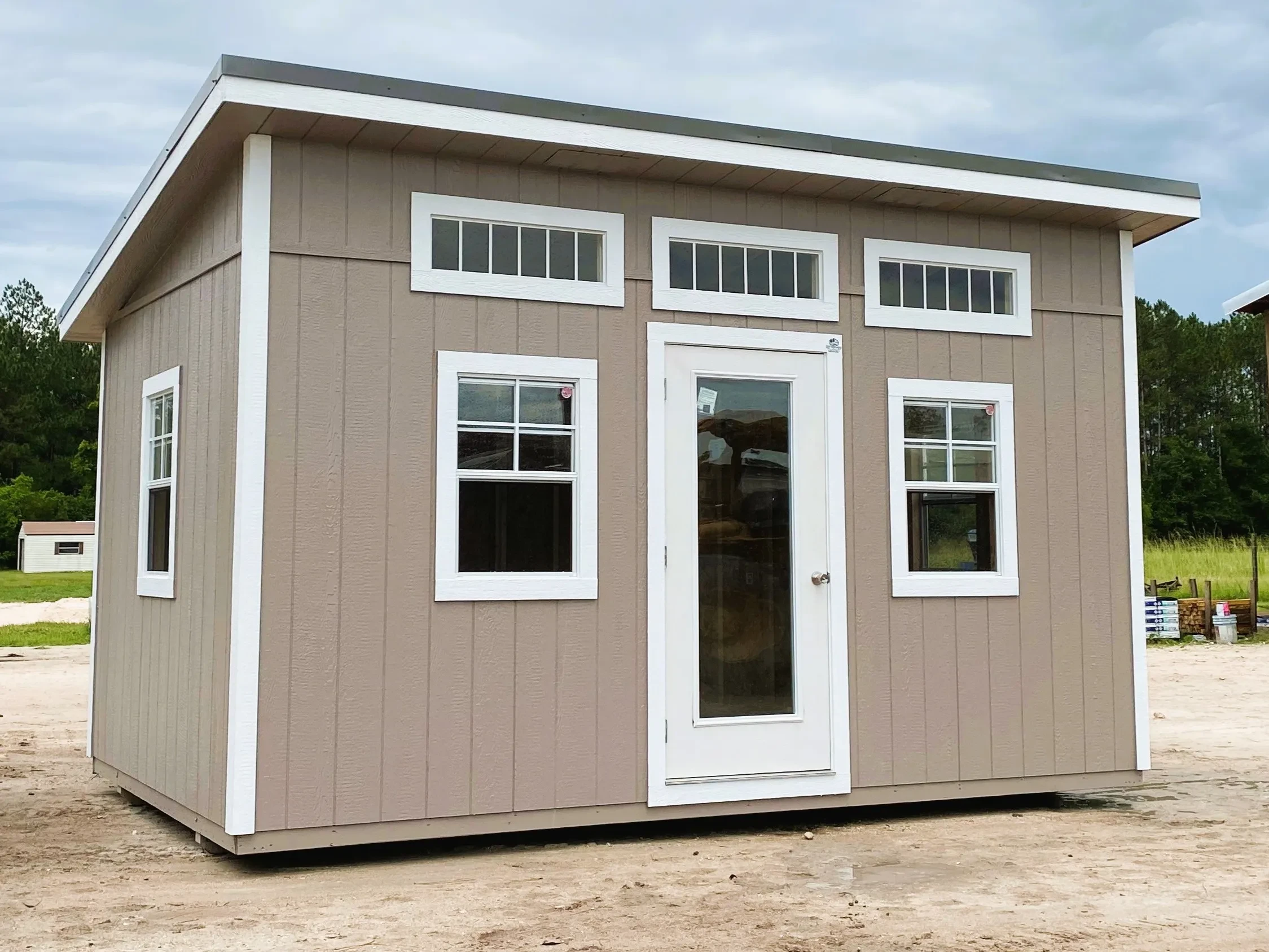 Exterior of a 10x16 urban with a walk-in door, windows and transoms