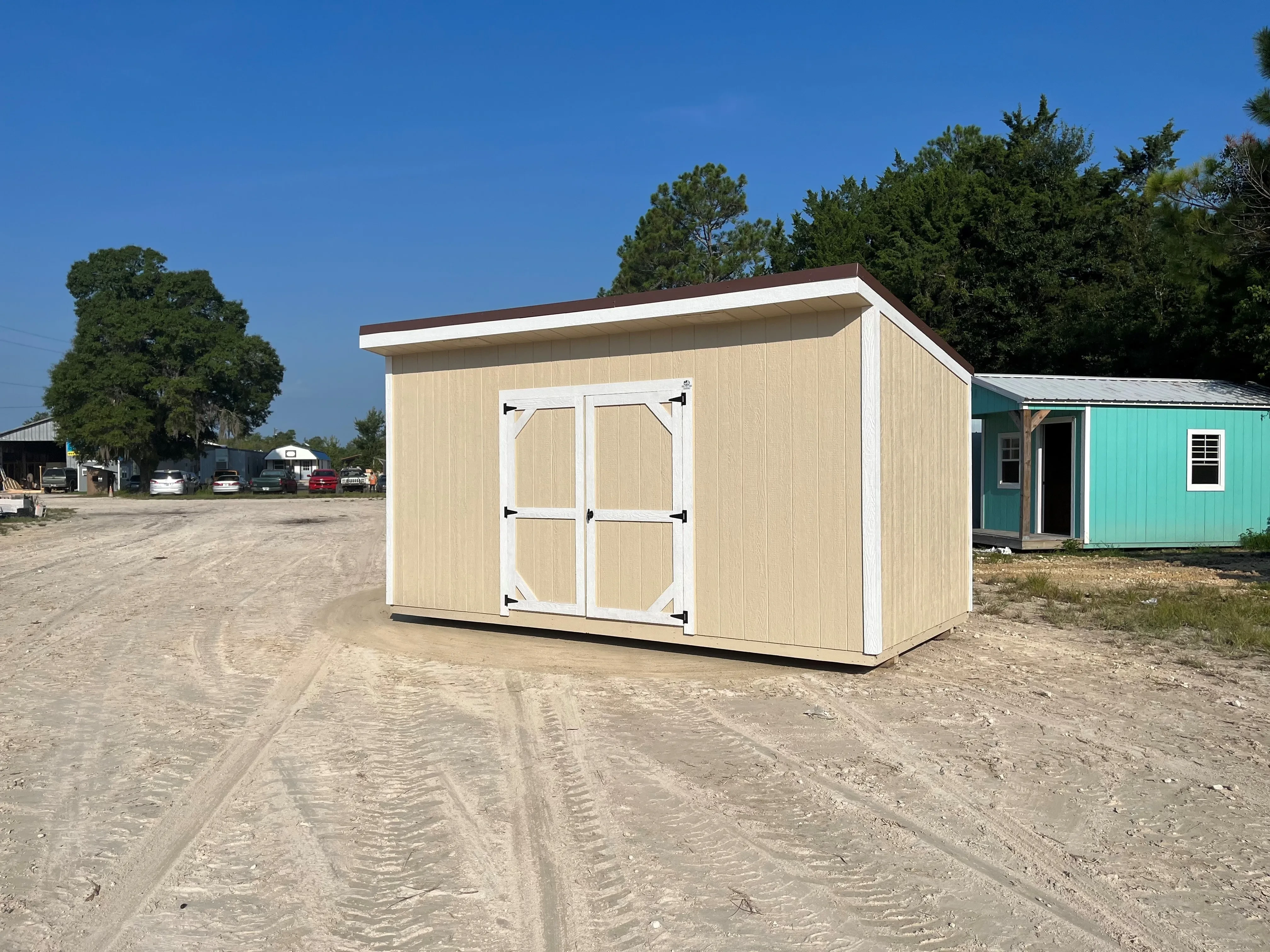 Exterior of an 8x16 almond urban with a double wood door