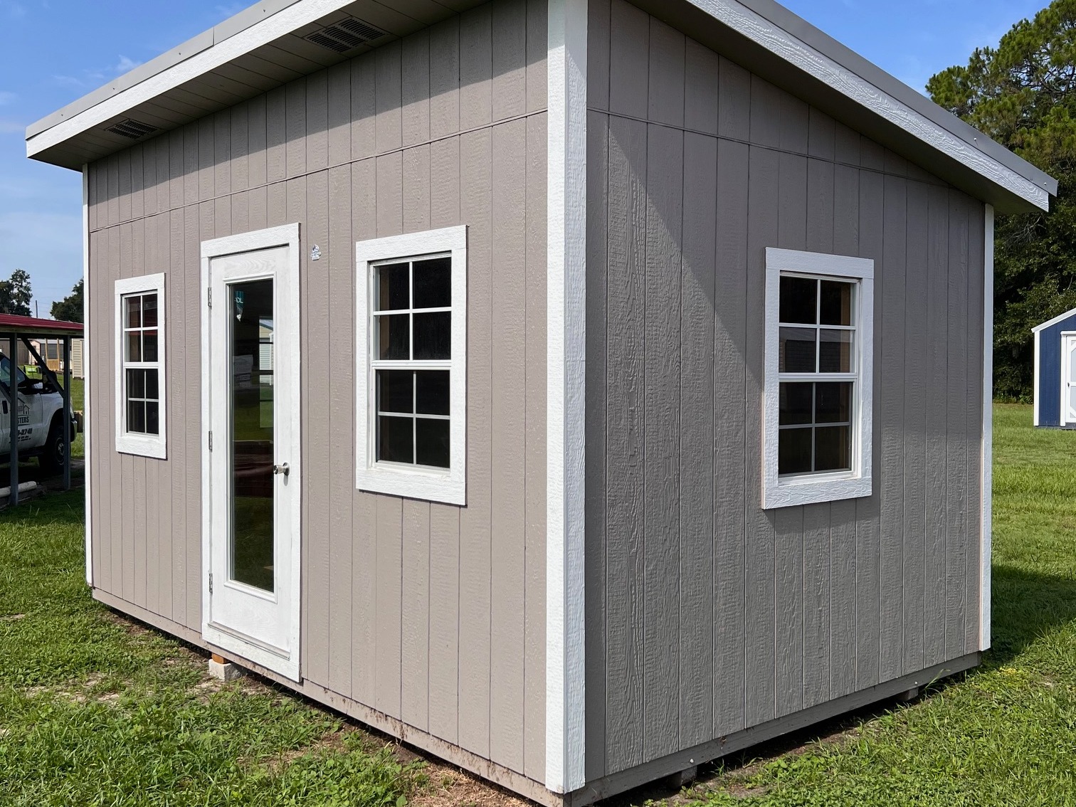 Exterior right corner showing the walk-in door, windows on front and window on side