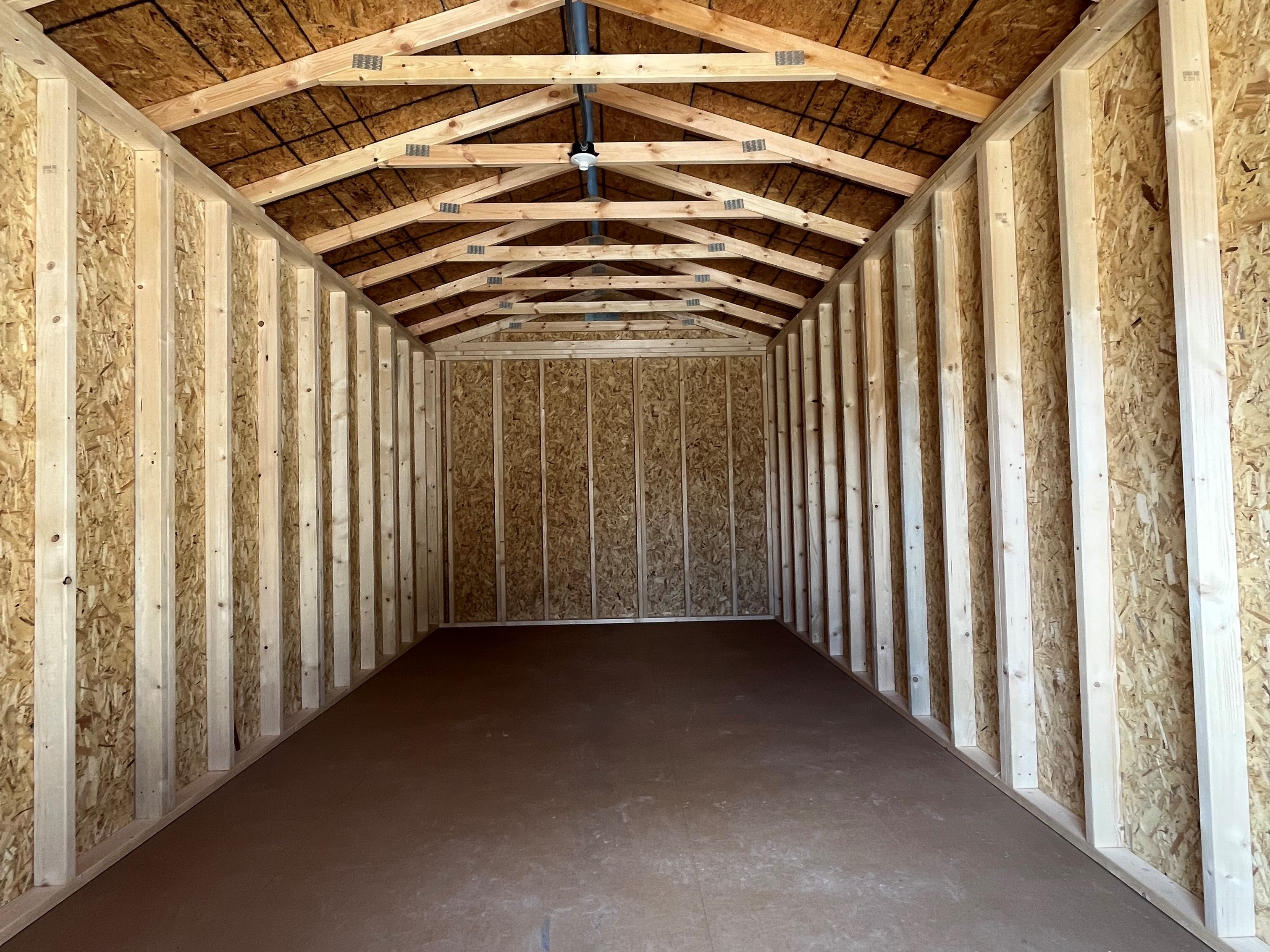 Interior of a 10x20 garden shed showing through the double wood door