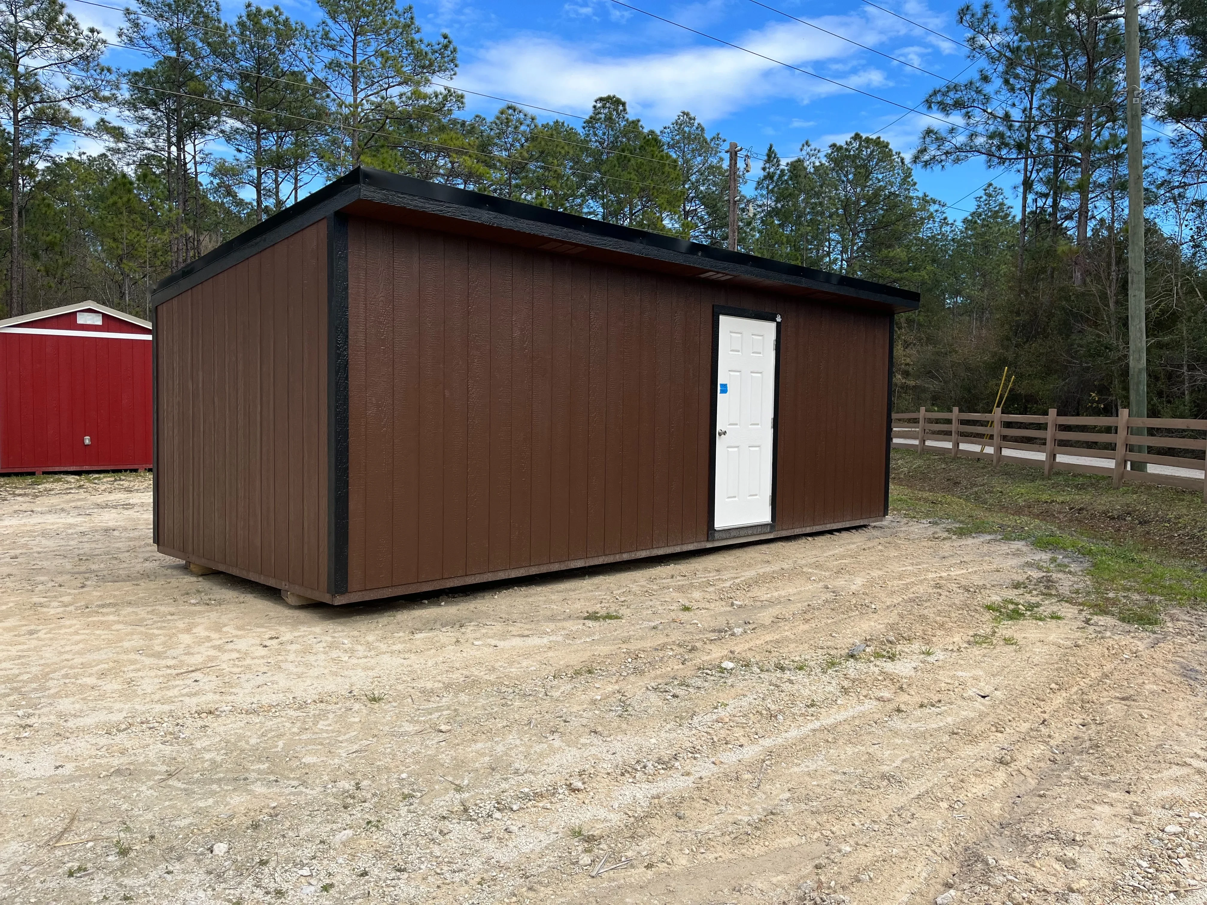 Exterior of a 10x24 dark brown urban with a walk-in door