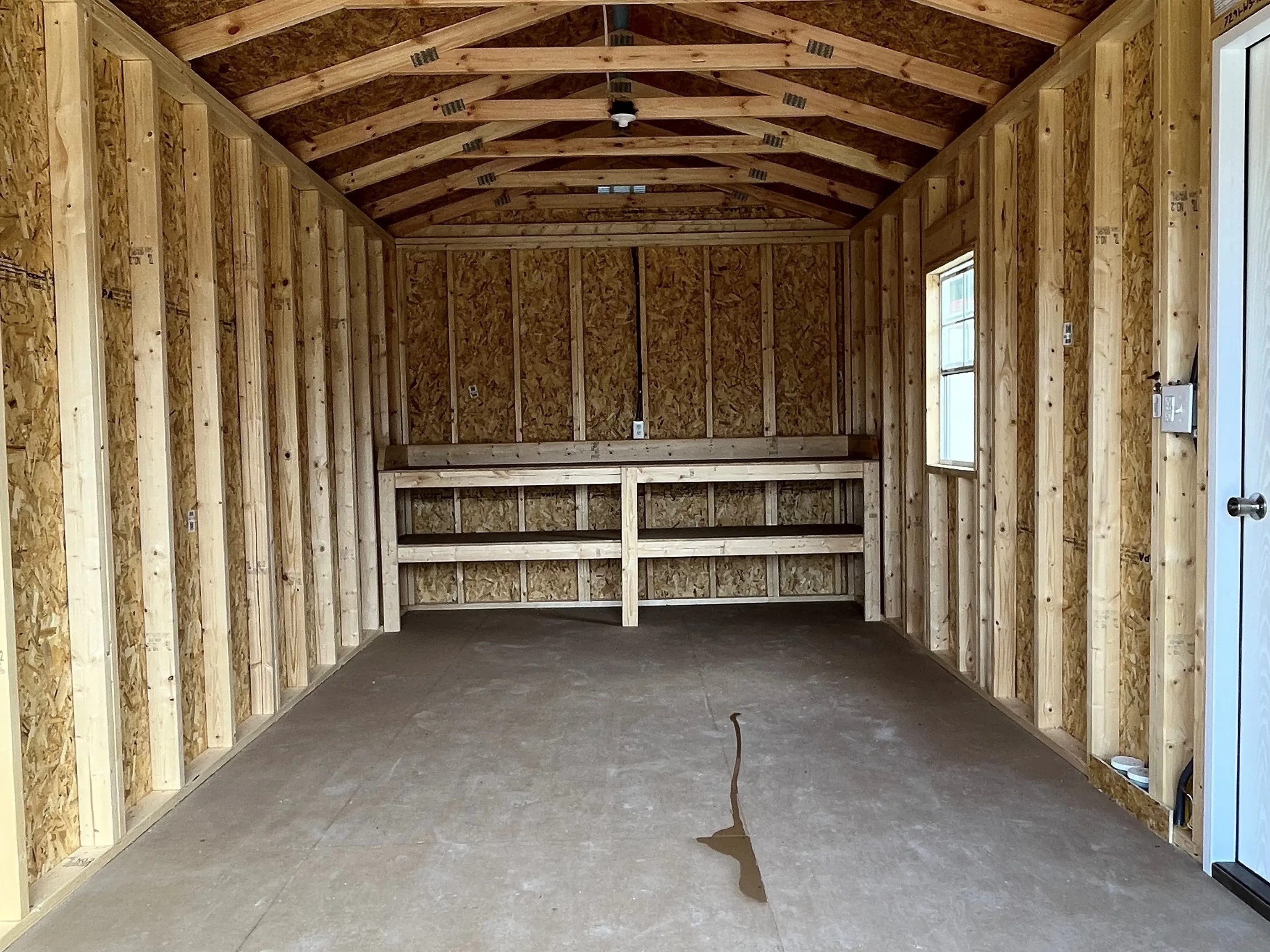 Interior of a 10x20 workshop showing a workbench and window