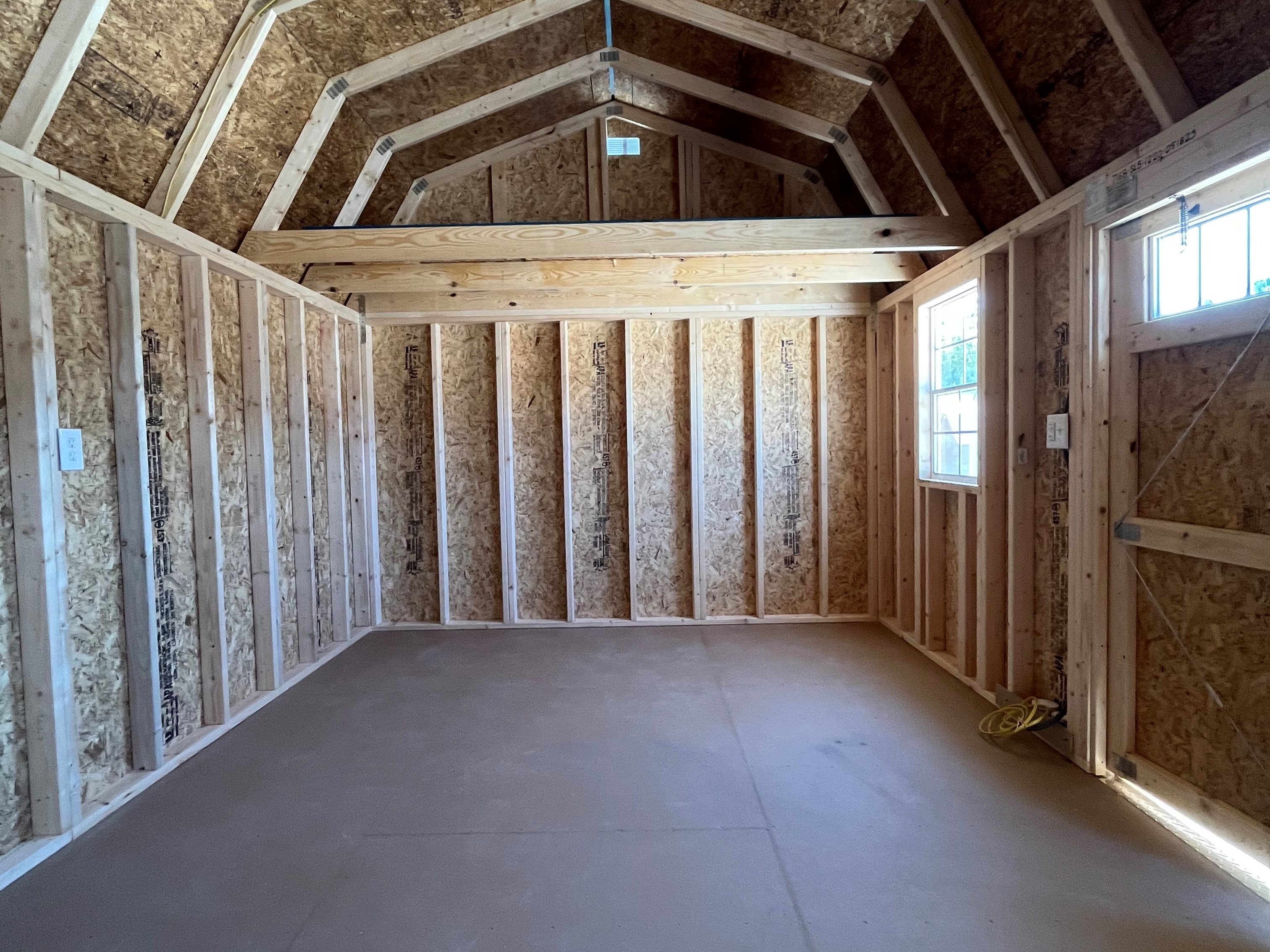 Interior of a 12x20 side lofted barn showing 4' loft in the end