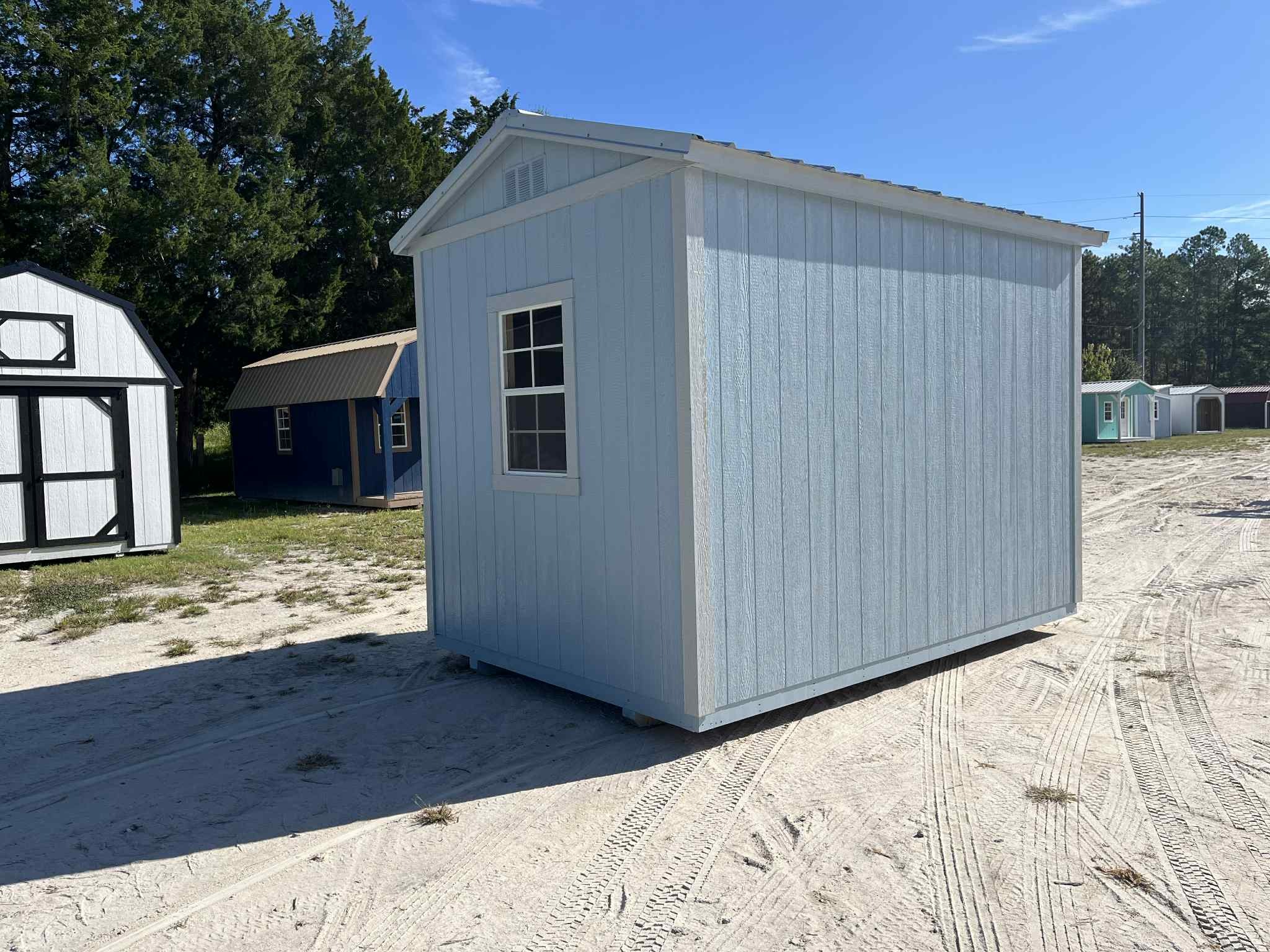 Exterior rear of a light blue 8x12 garden shed showing a window
