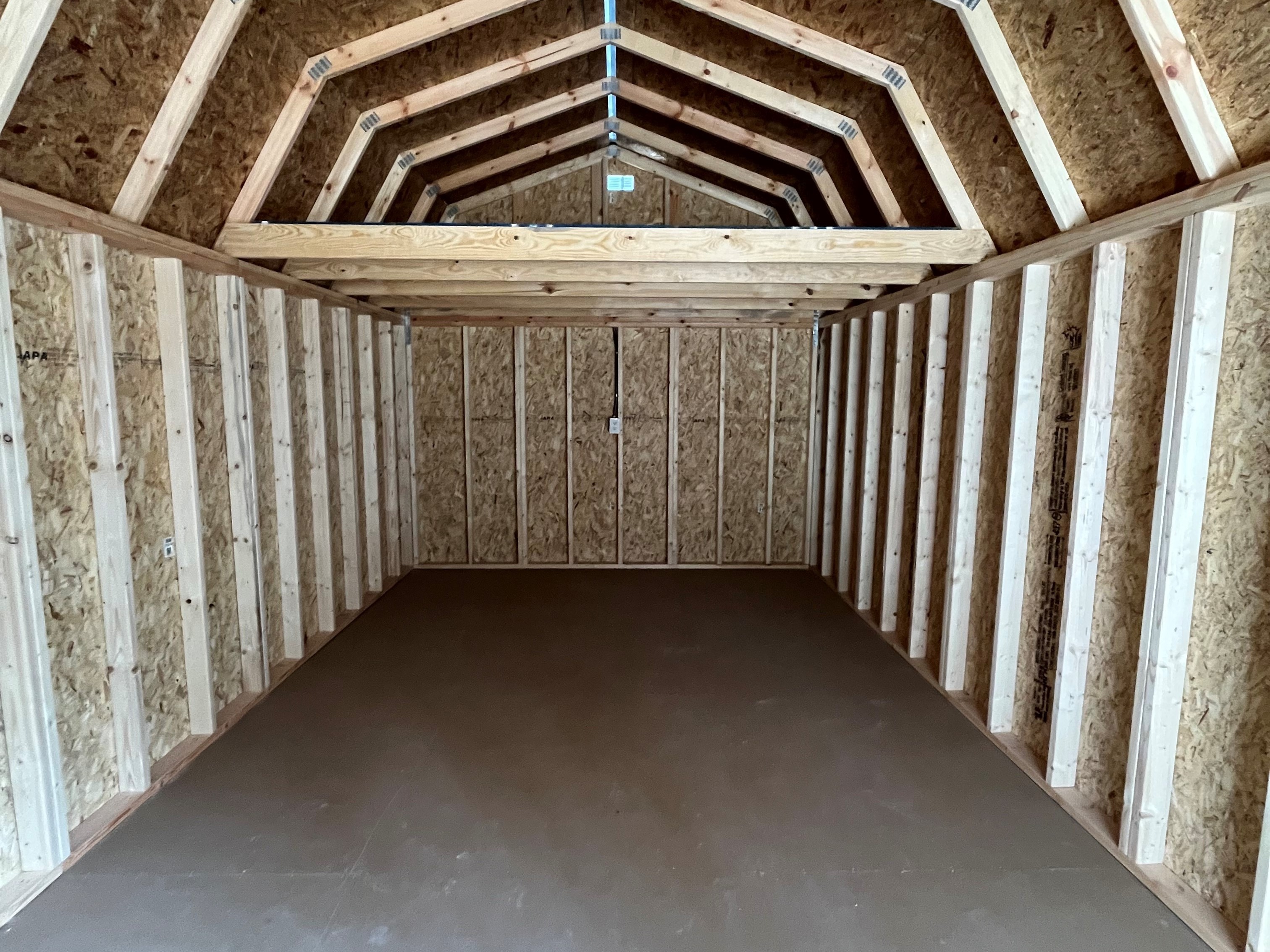 Interior of 12x32 deluxe lofted barn cabin showing a large loft in back