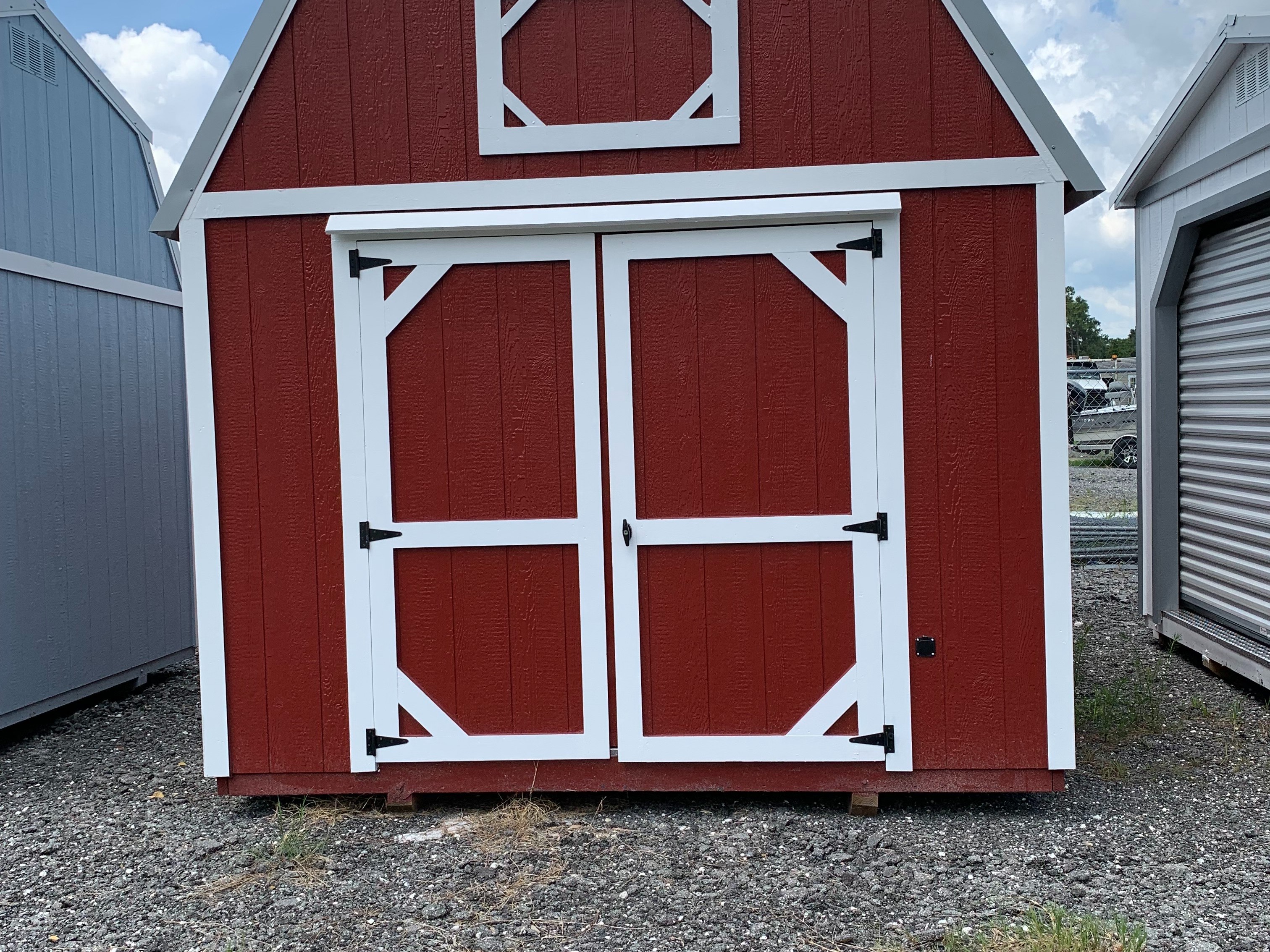 Exterior of the 10x16 red lofted barn with double wood doors