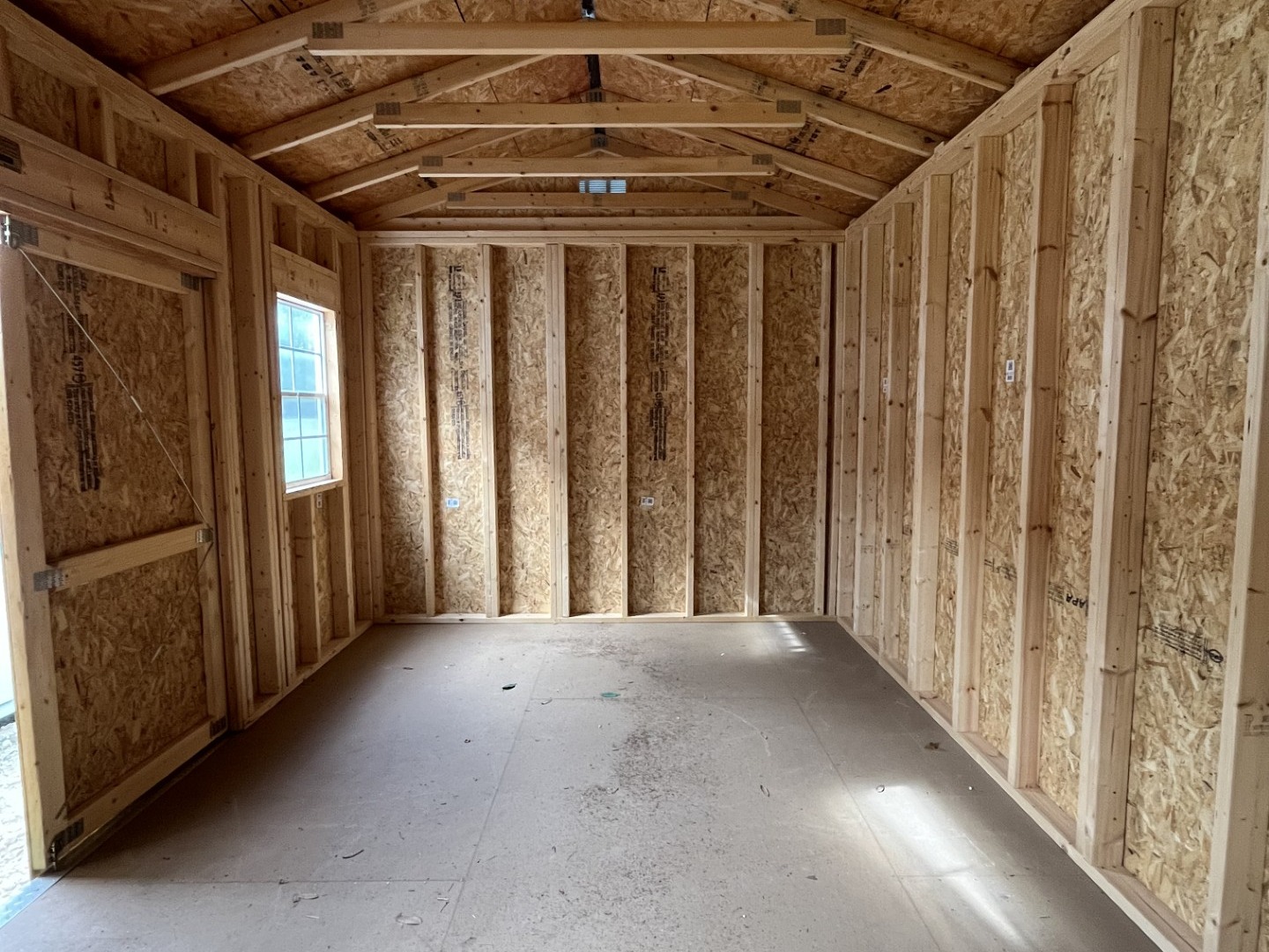 Interior view of a 10x16 side garden shed showing a window and door
