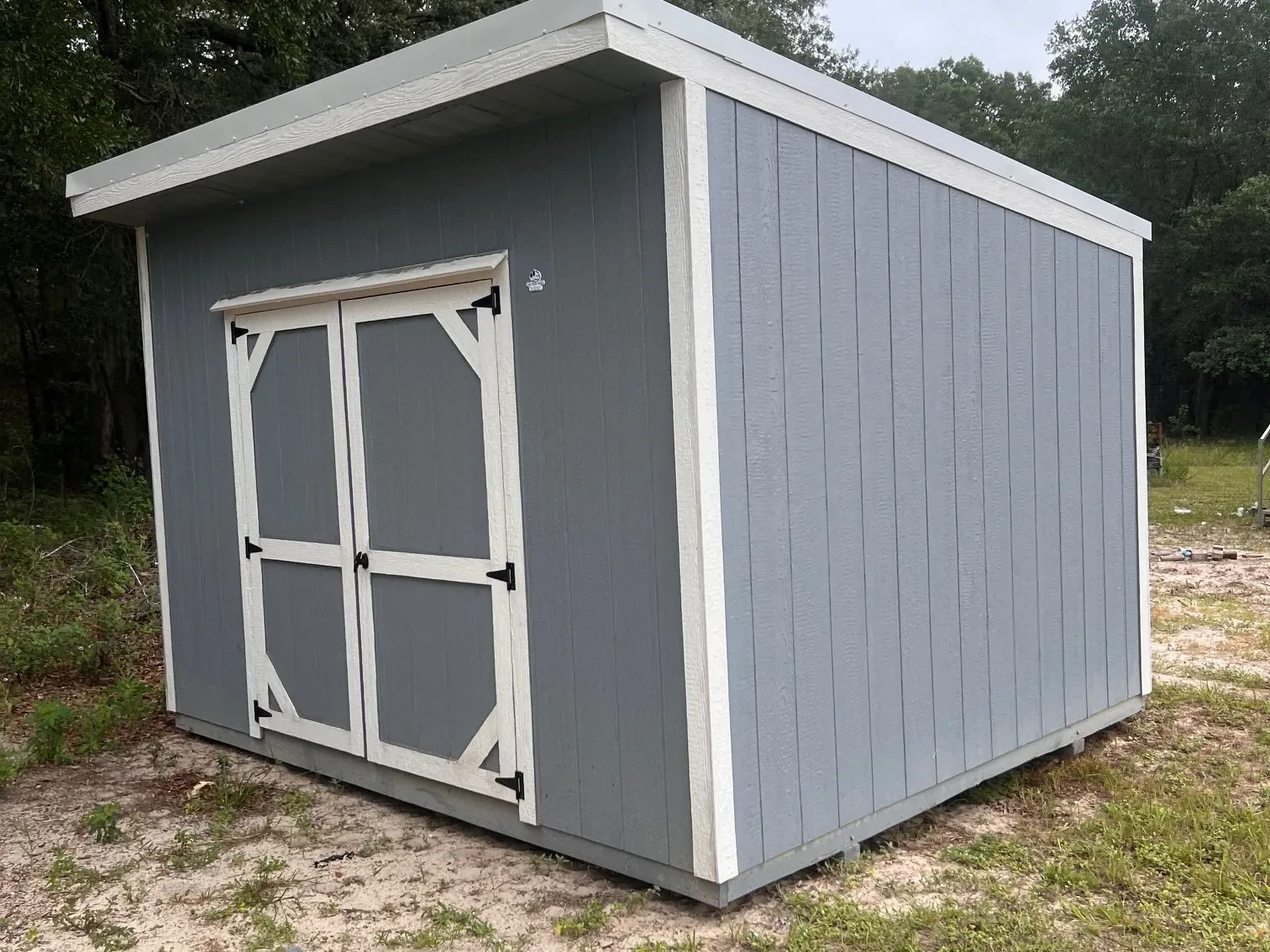 exterior of a 10x12 dark grey urban with double wood doors