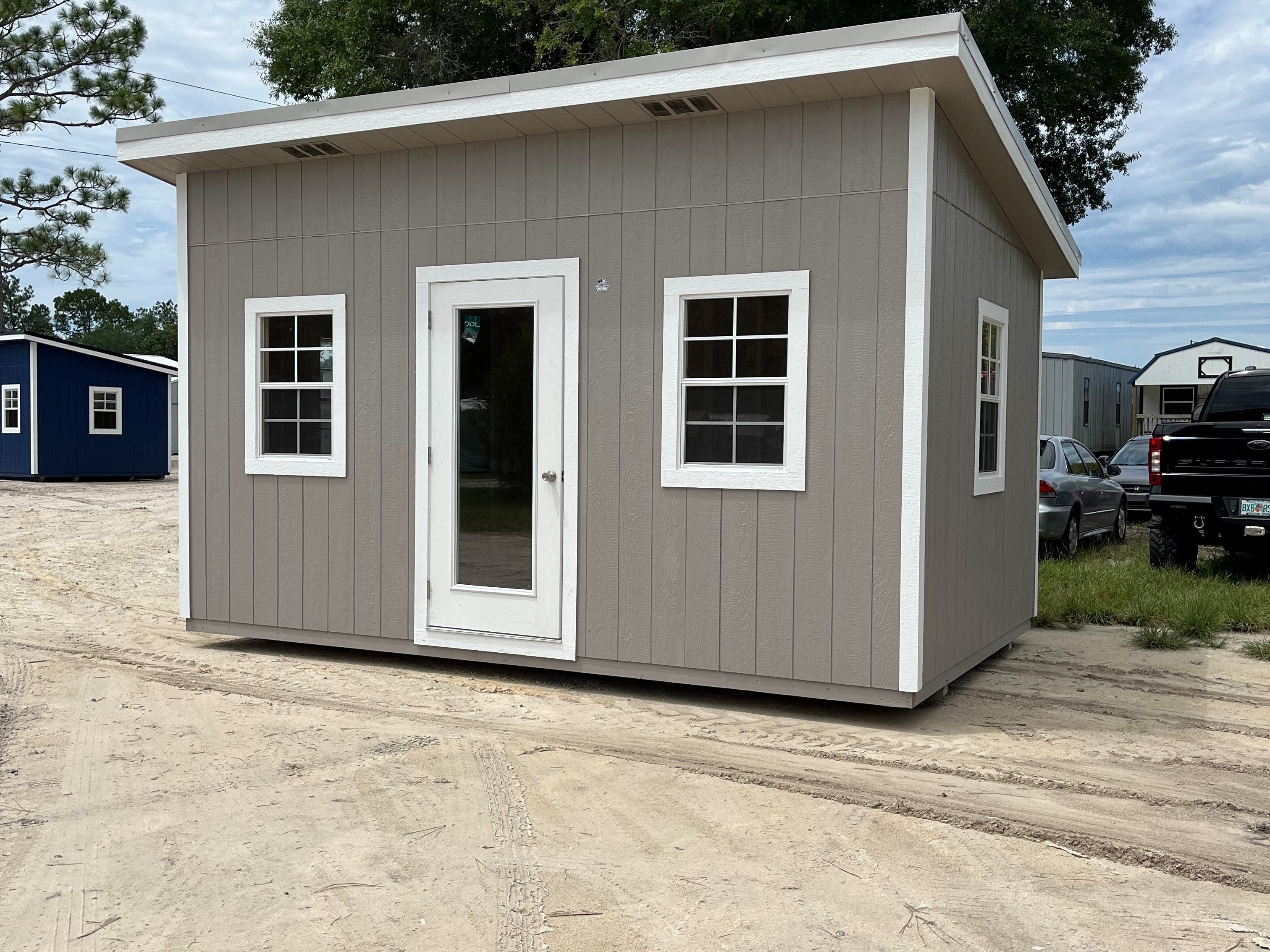 Exterior of a 10x16 urban with a walk-in door and windows on the front