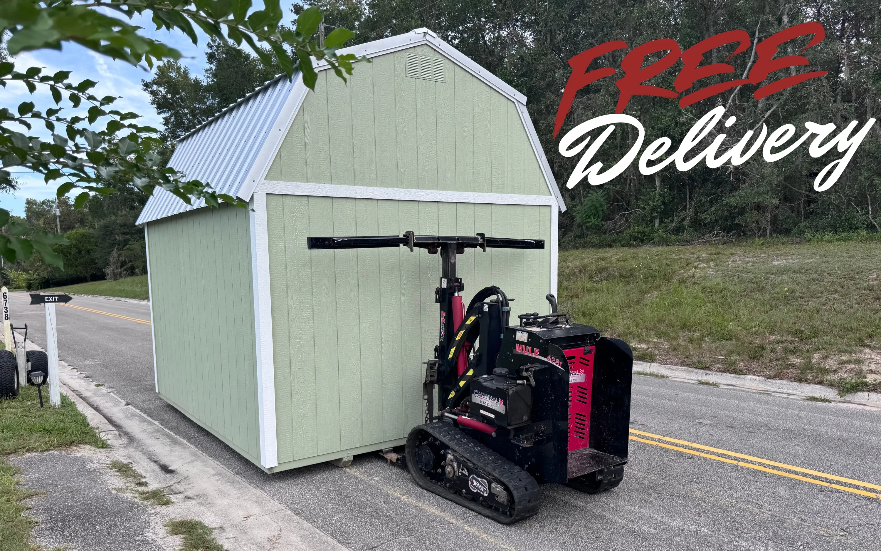 A shed moving tractor moving a shed down the road