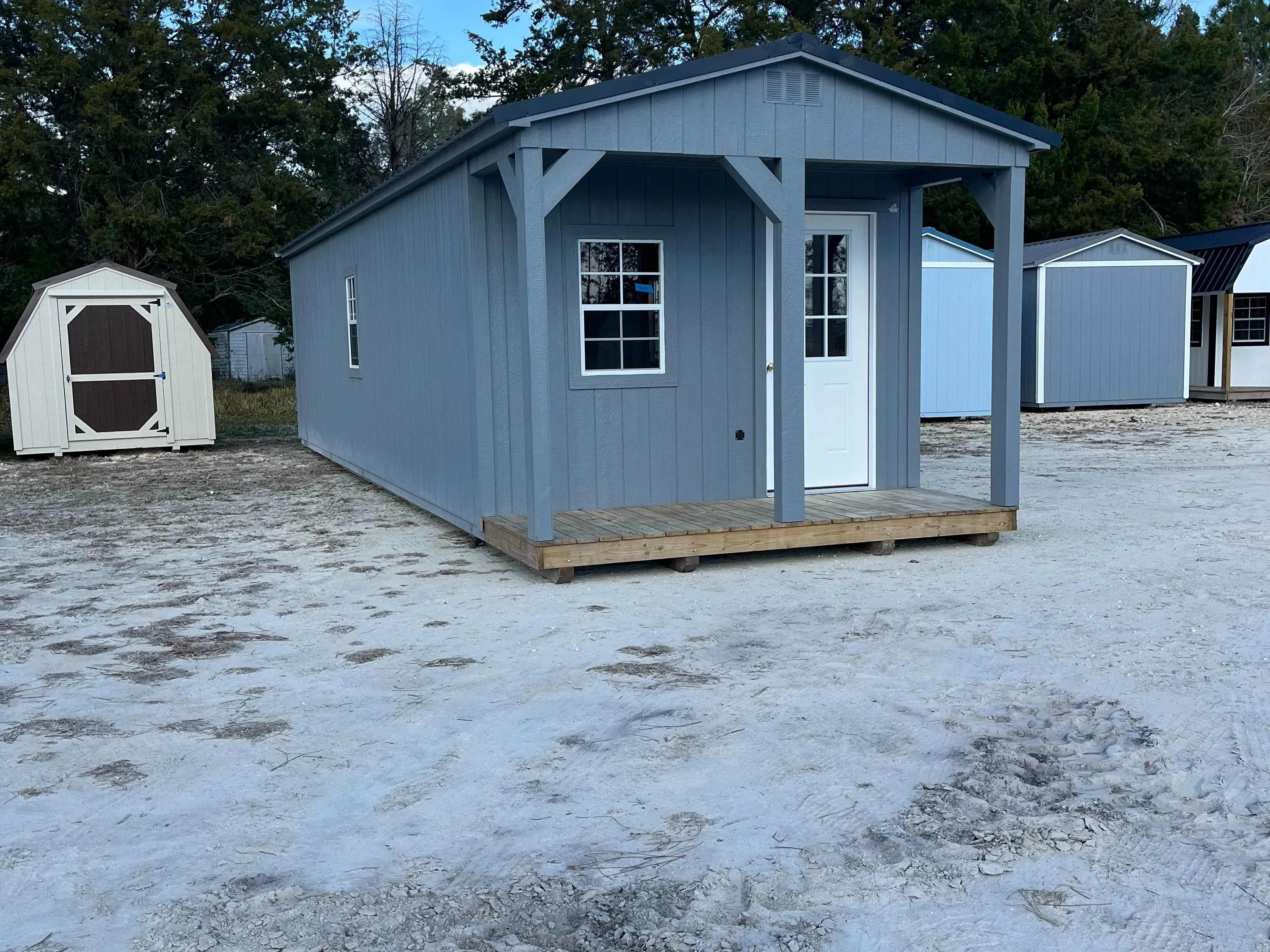 Exterior of a Dark grey 12x36 Cabin with a walk-in door and windows