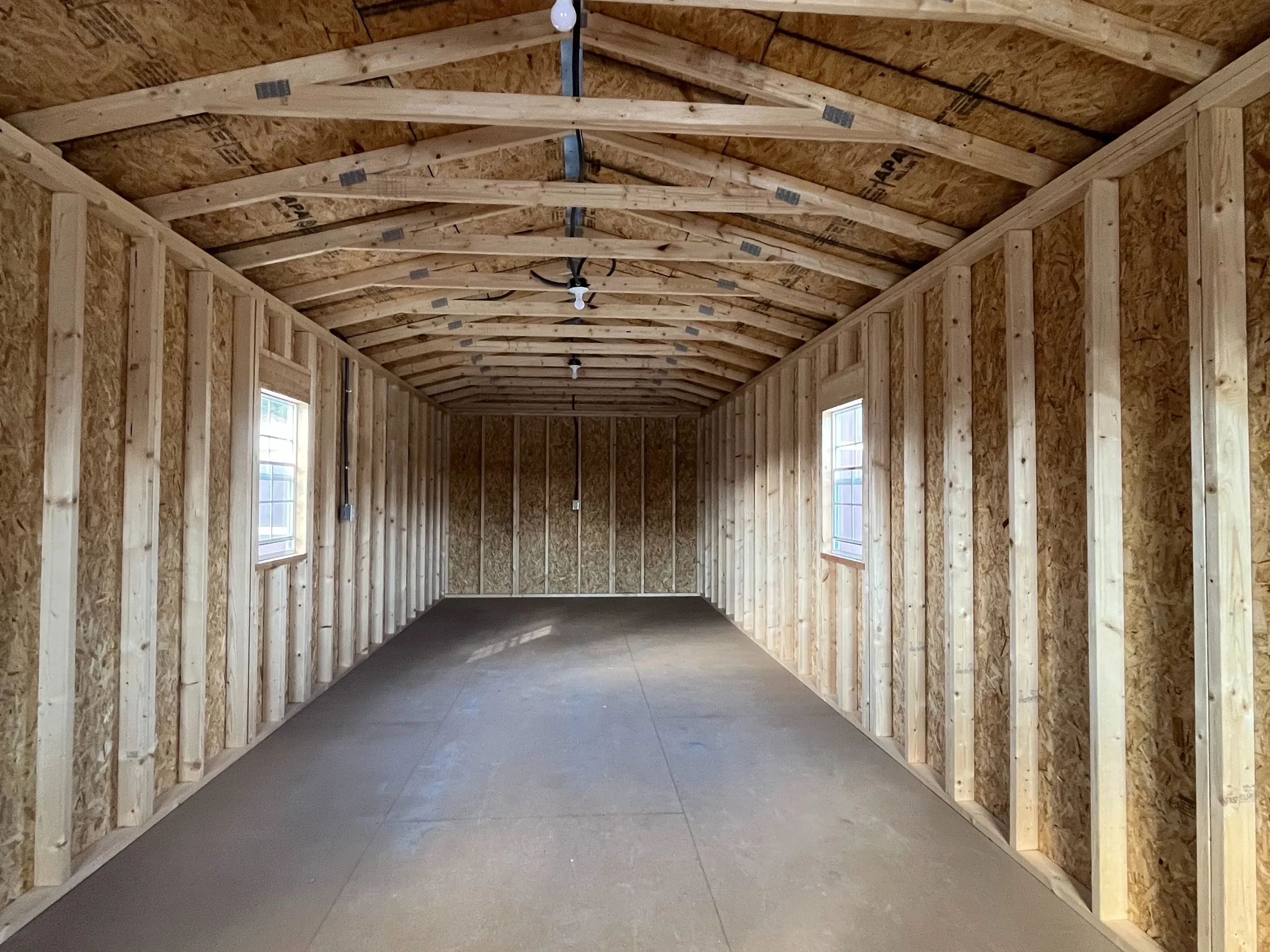 Interior of a 12x36 cabin through the walk-in door showing the windows and electric