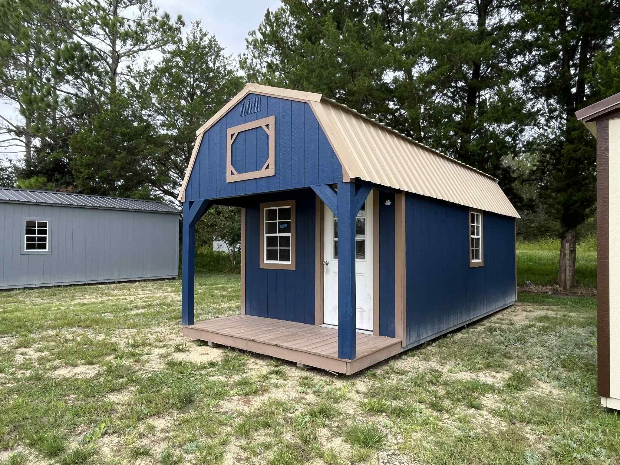 Exterior view of a 10x24 lofted barn cabin showing the porch, walk-in door and windows