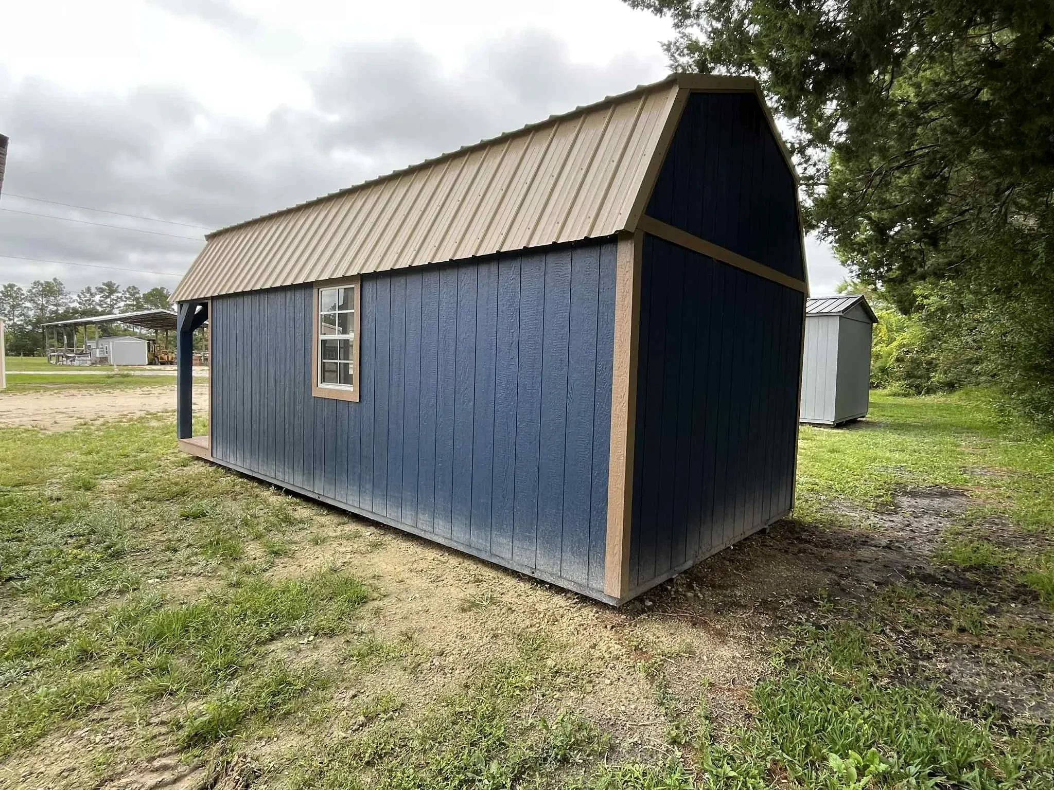 Exterior rear of a 10x24 lofted barn cabin viewing a window on the side