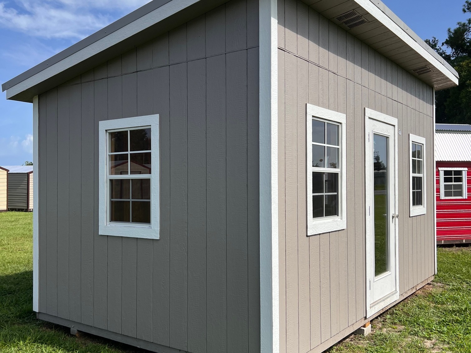 Exterior left corner showing the walk-in door, windows on front and window on side
