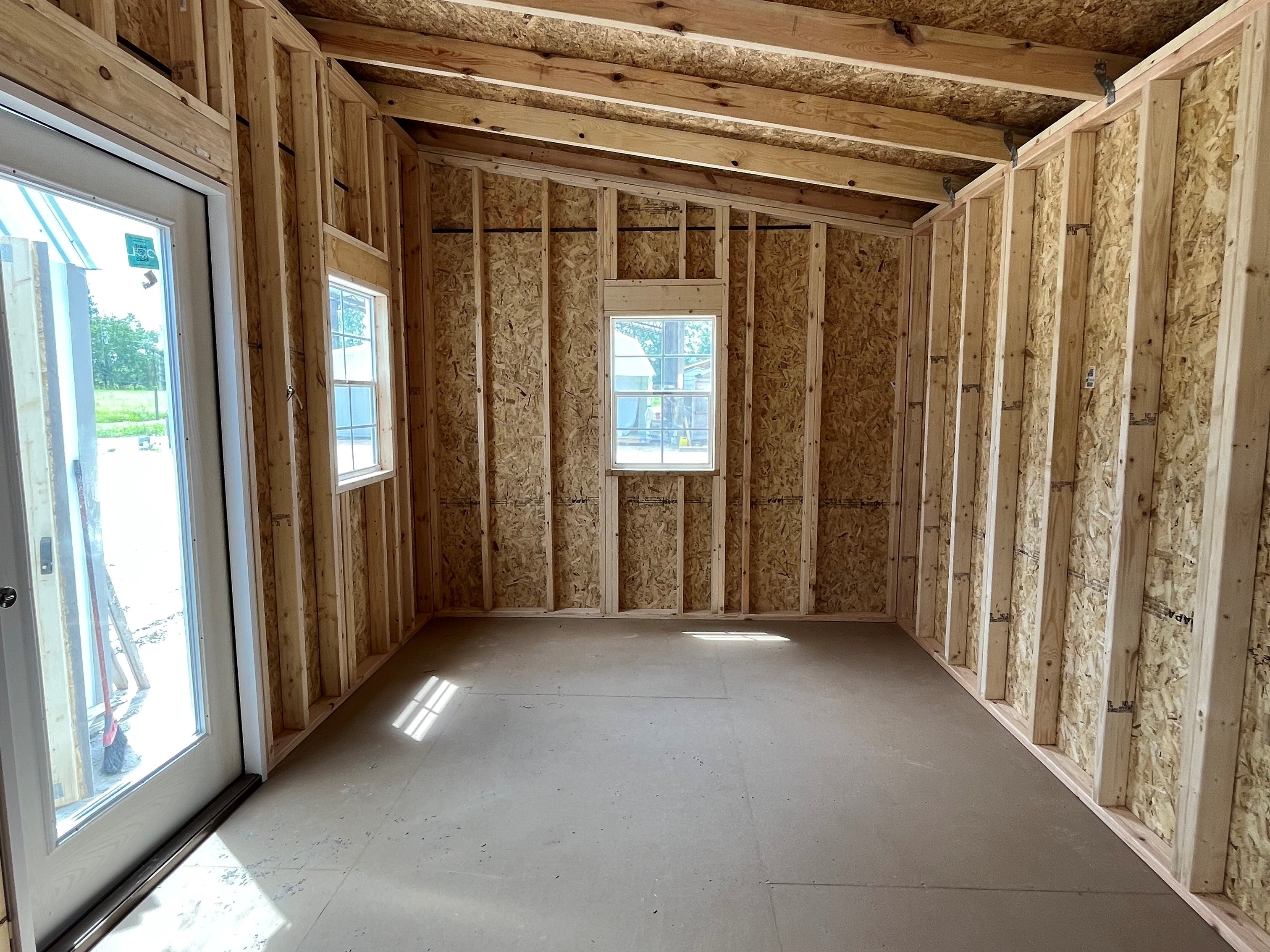 Interior left side view of a 10x16 urban showing the walk-in door and windows