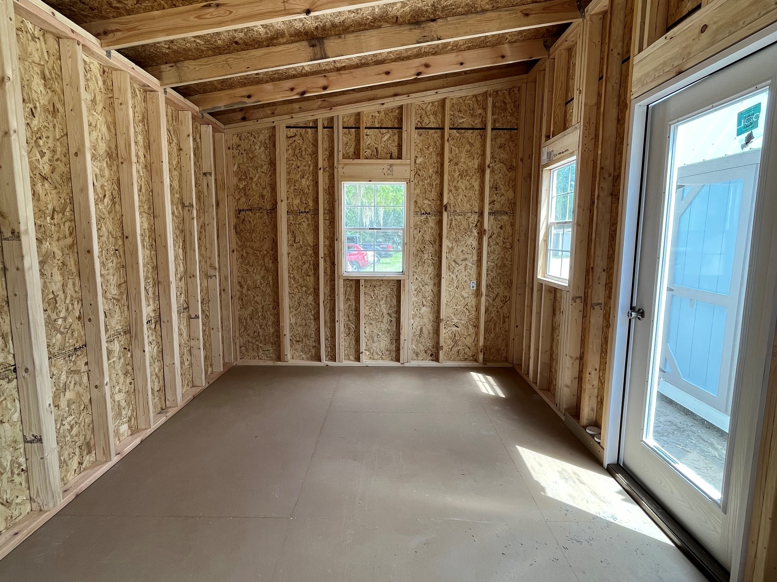 Interior right side view of a 10x16 urban showing the walk-in door and windows