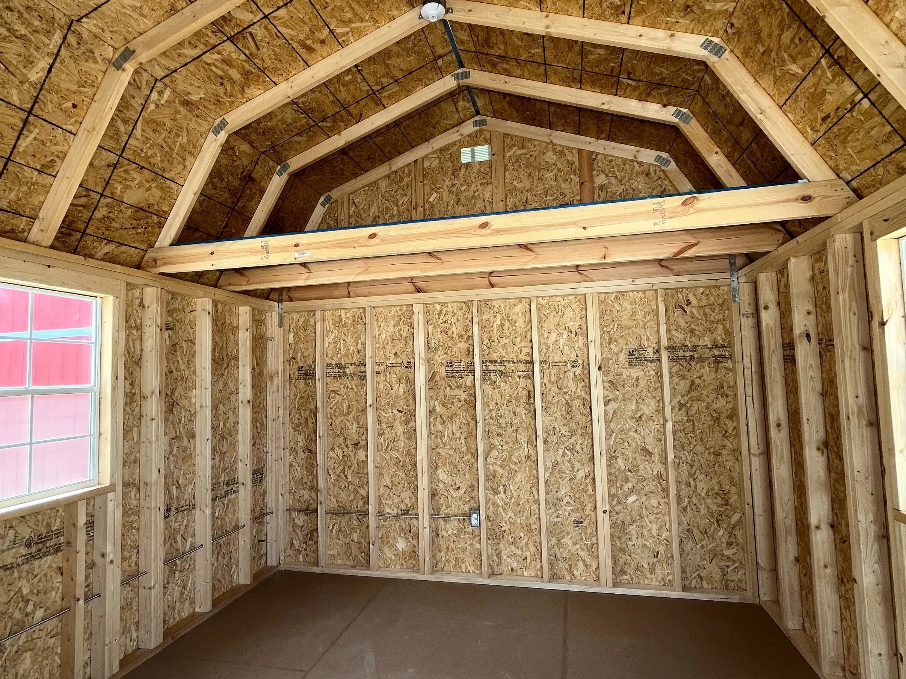 Interior of a 12x16 Lofted Barn Cabin showing windows and loft area