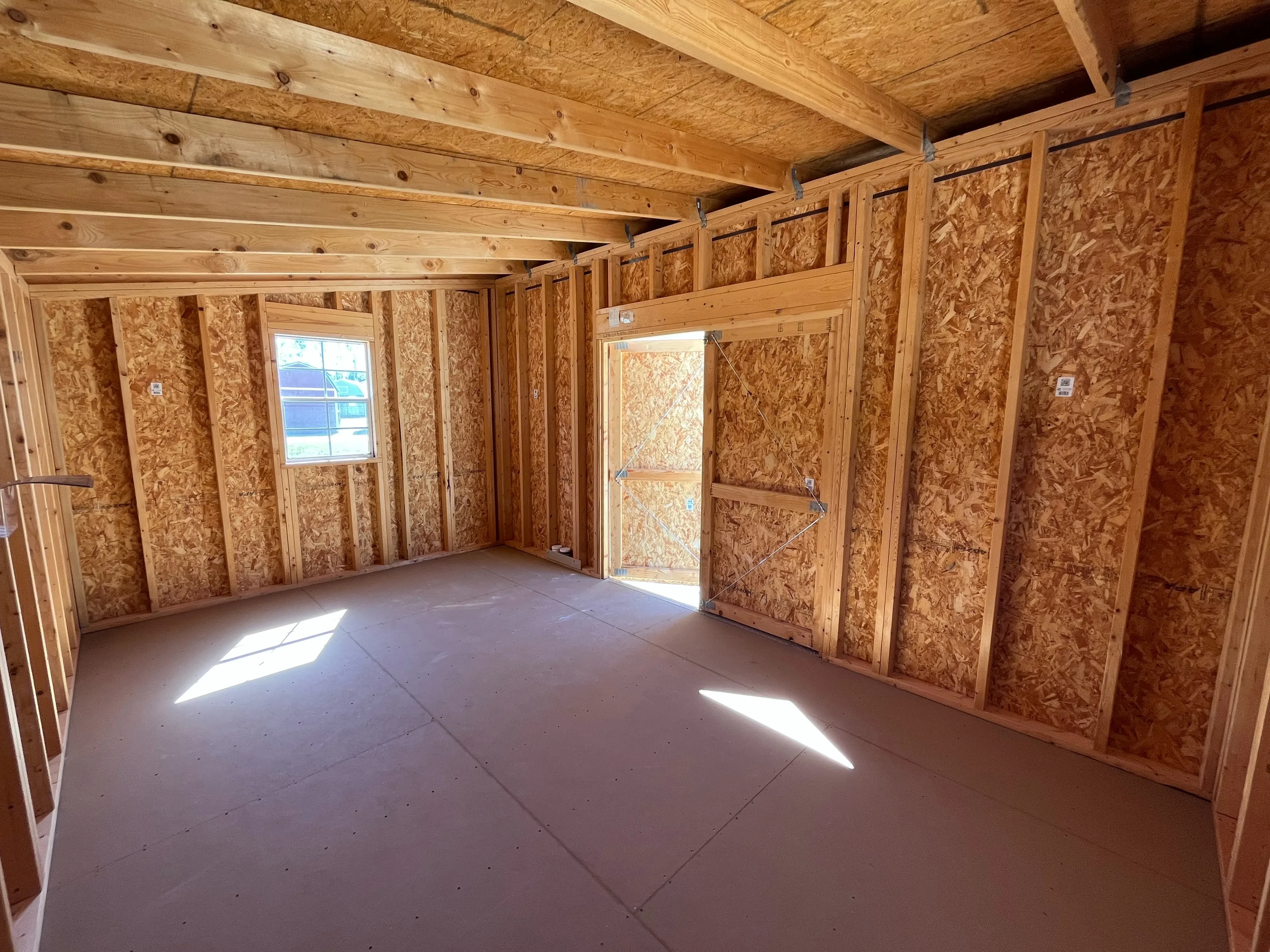 Interior of a 10x12 urban shed showing a window a double wood door