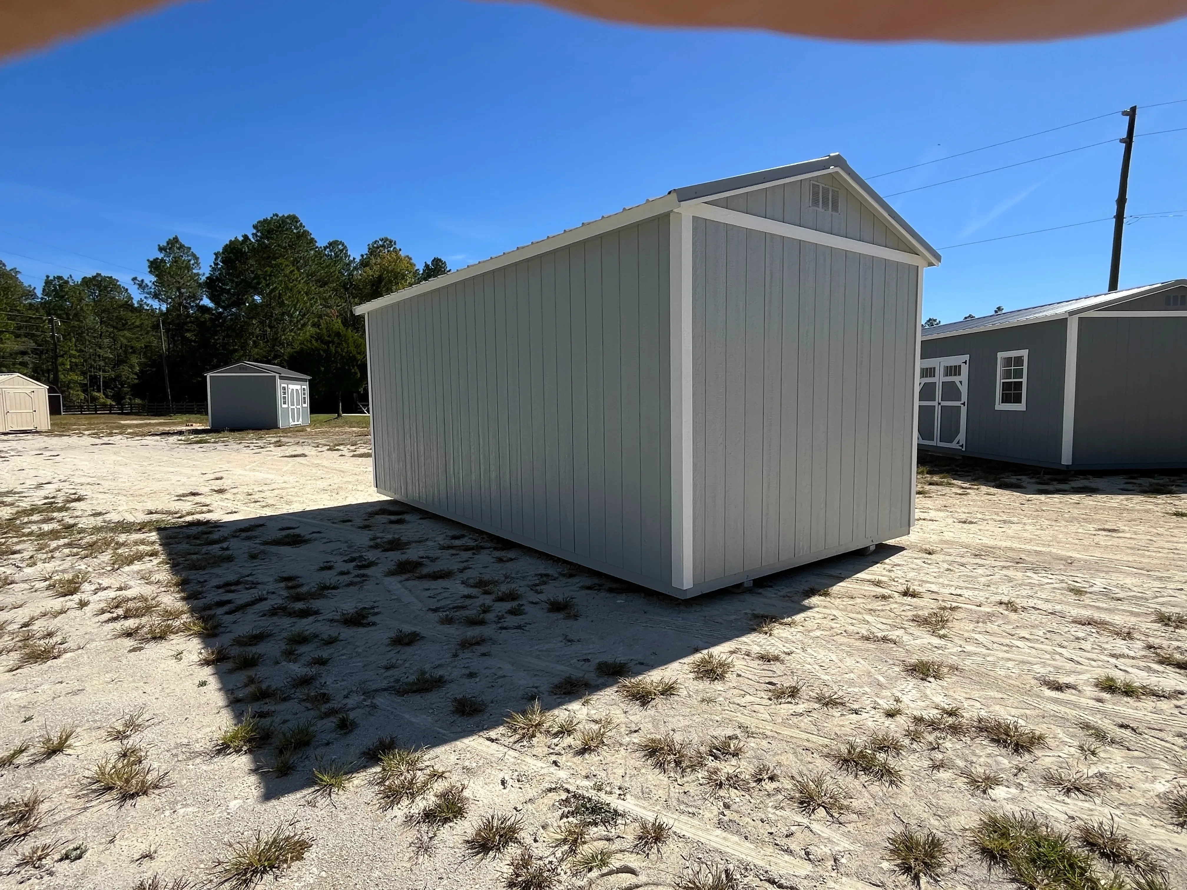 Exterior rear of a light grey 10x20 side garden shed