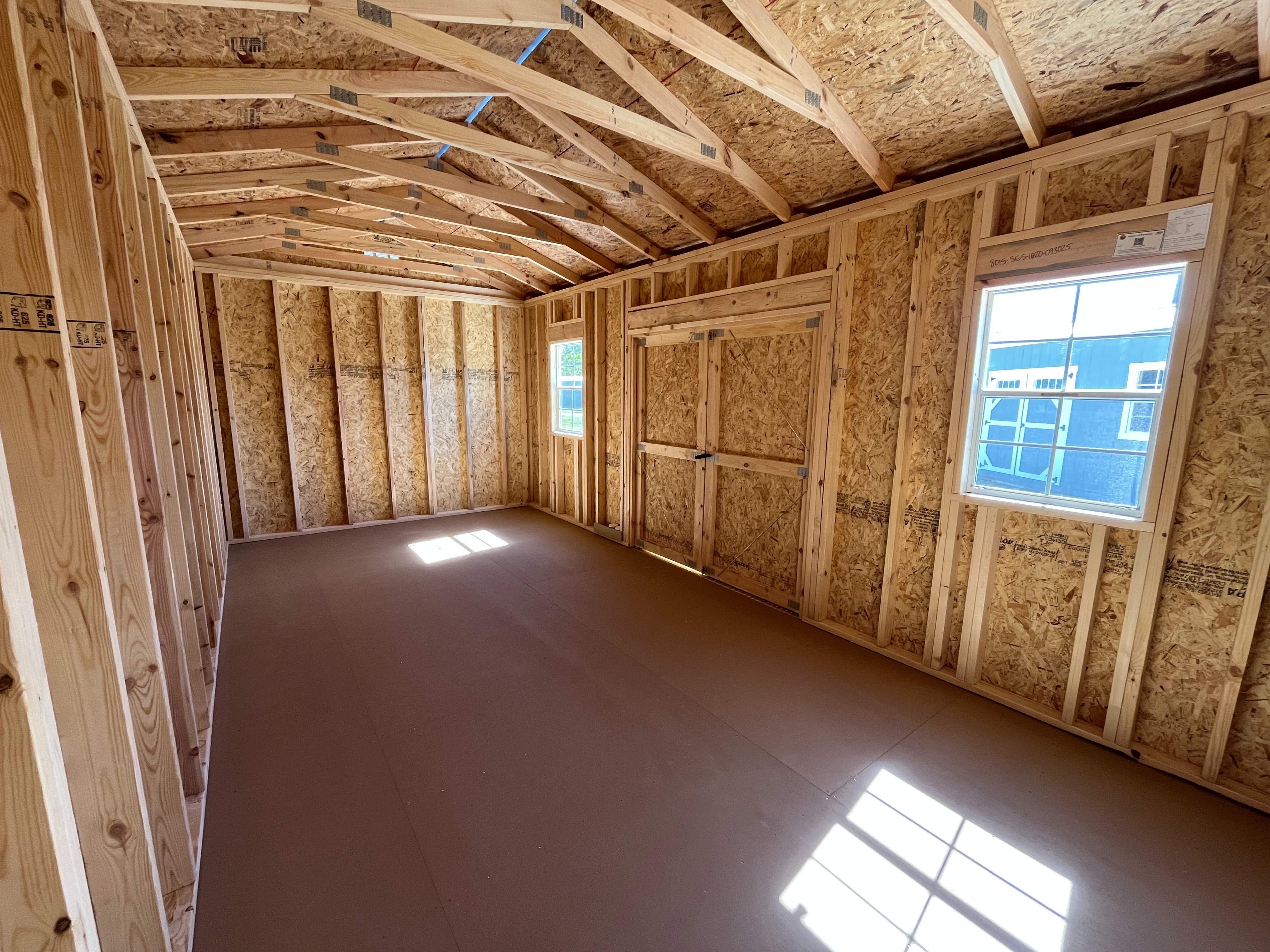 Interior of a 10x20 side garden shed showing windows and double door