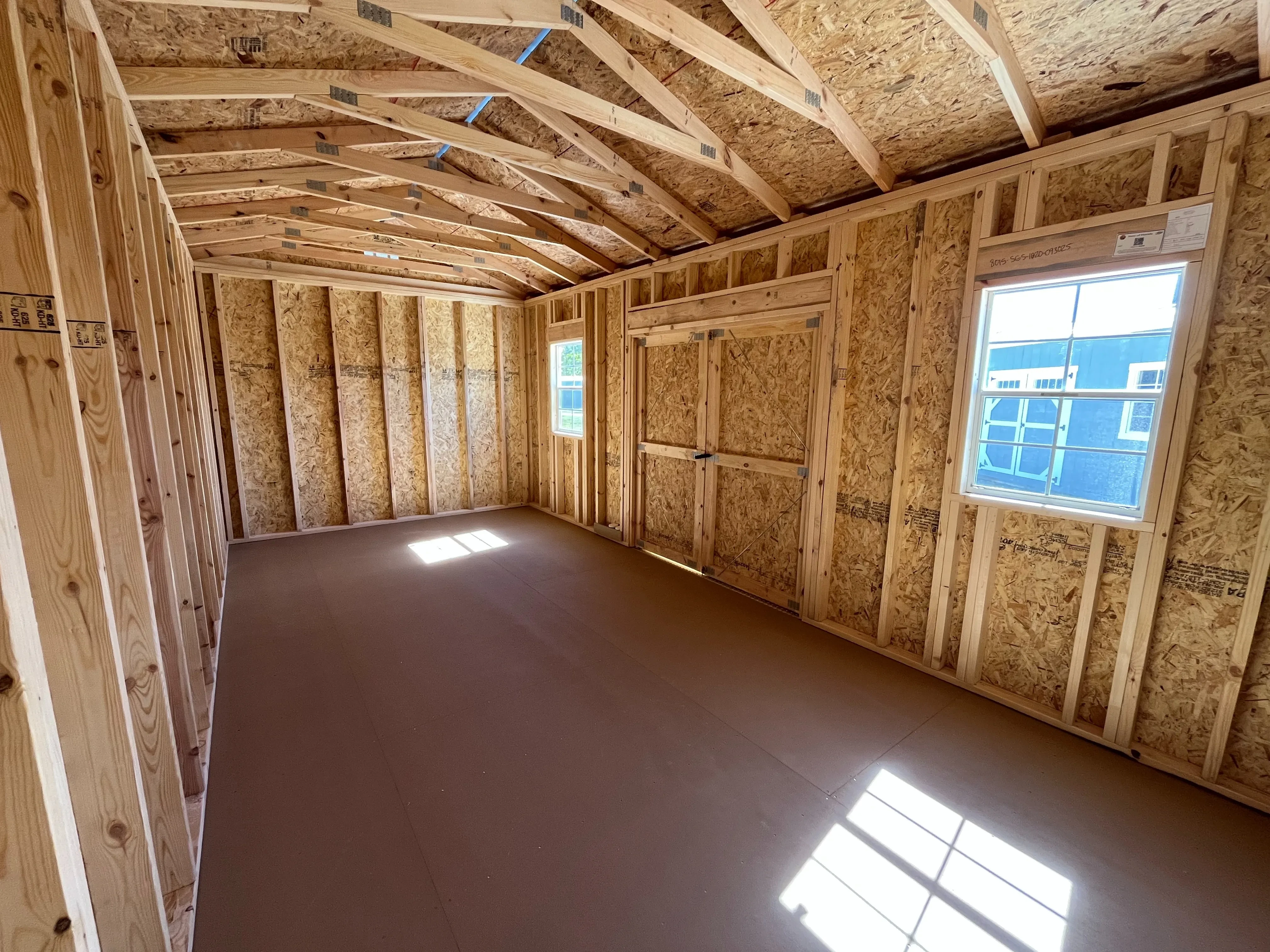 Interior of a 10x20 side garden shed showing windows and double door