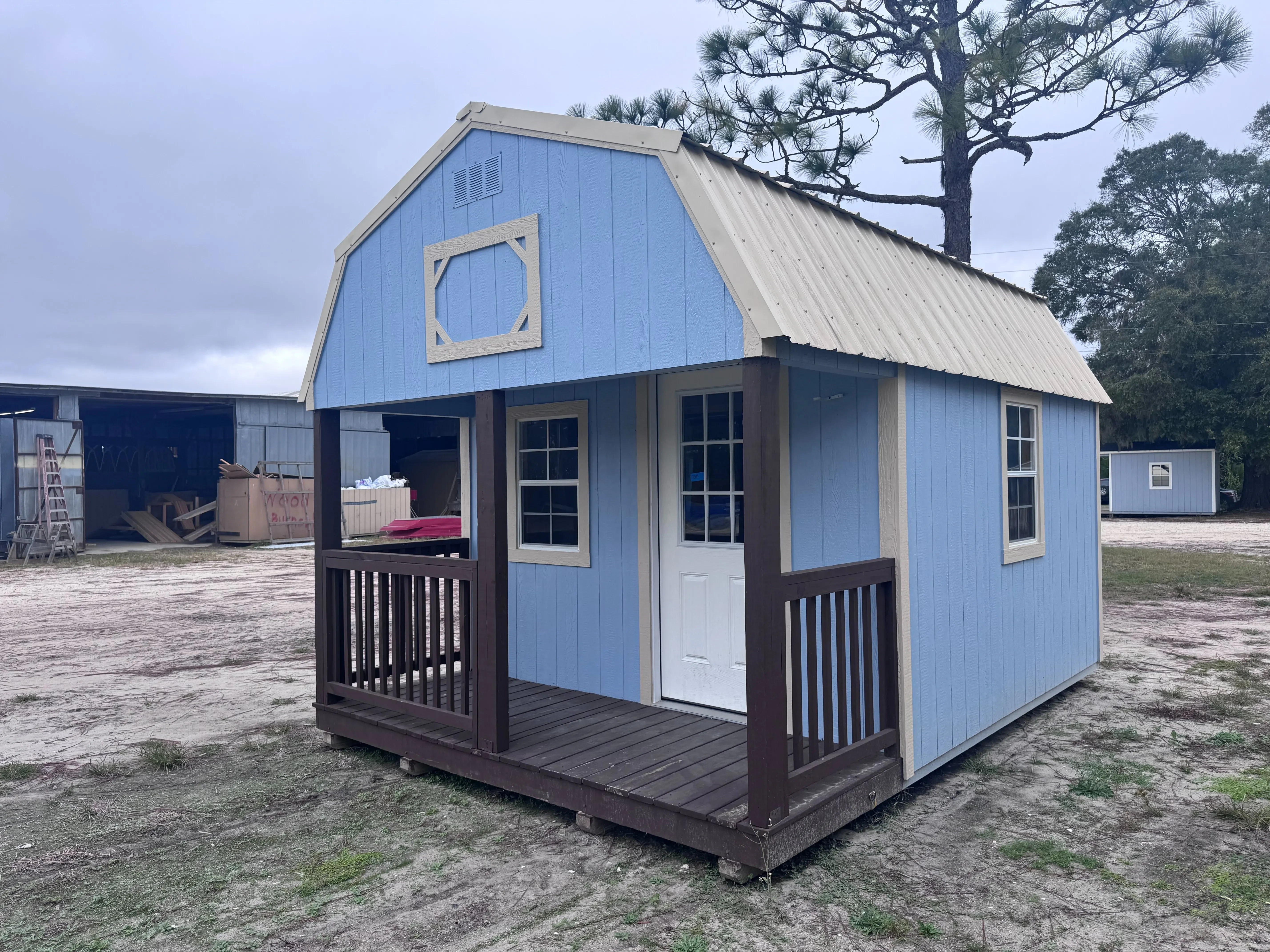 12x16 Lofted Barn Cabin with Dockside Blue siding, Almond trim, Ivory roof, and brown porch