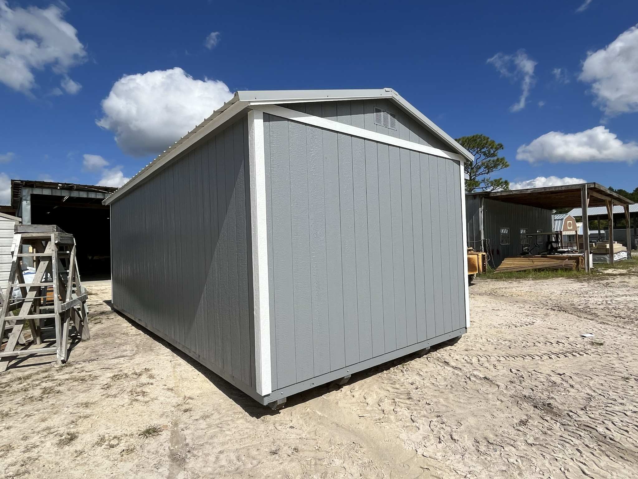 Exterior rear of a light grey 10x20 side garden shed 