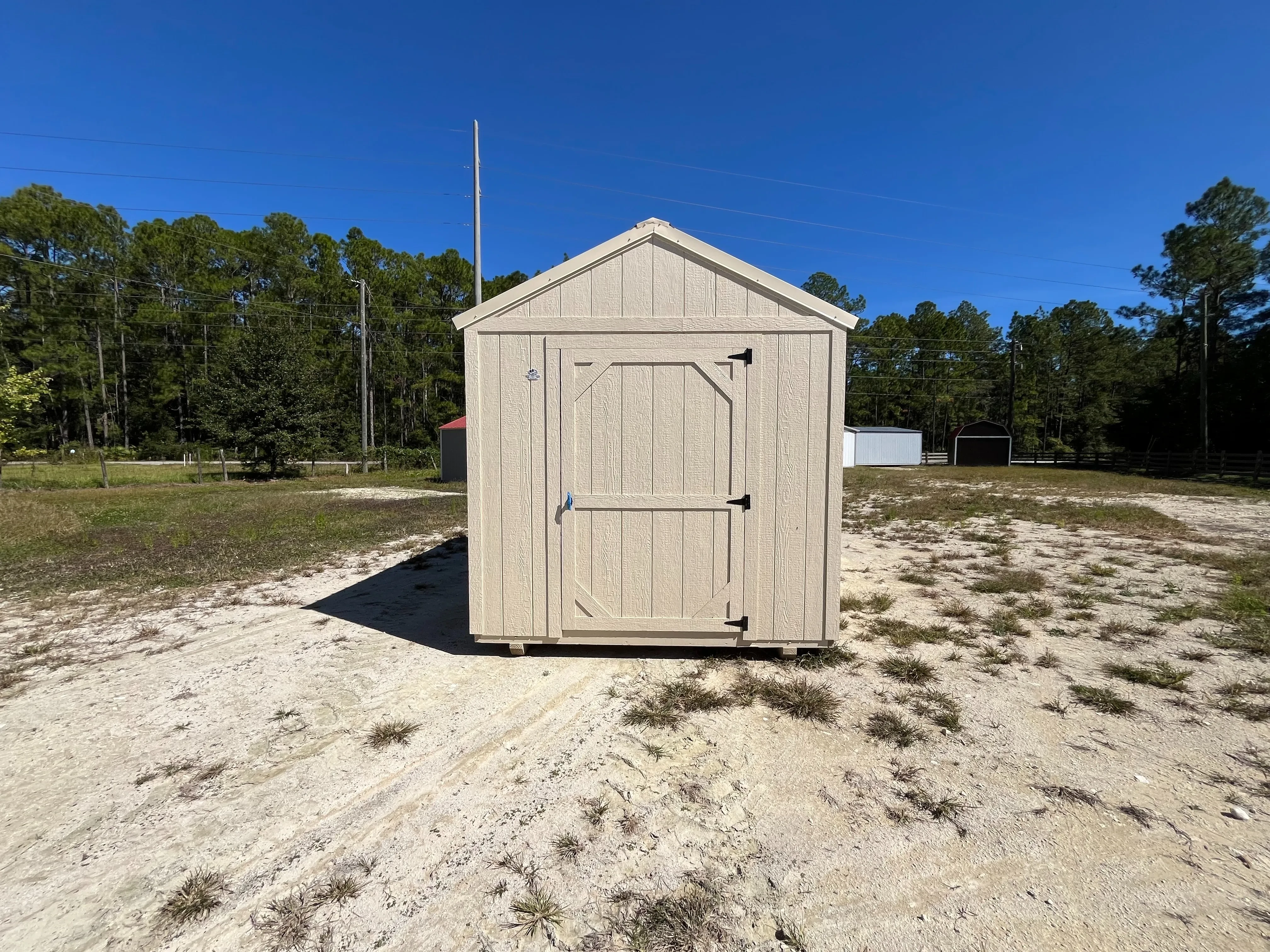 Exterior photo of an almond 8x12 Garden Shed Economy showing entry door