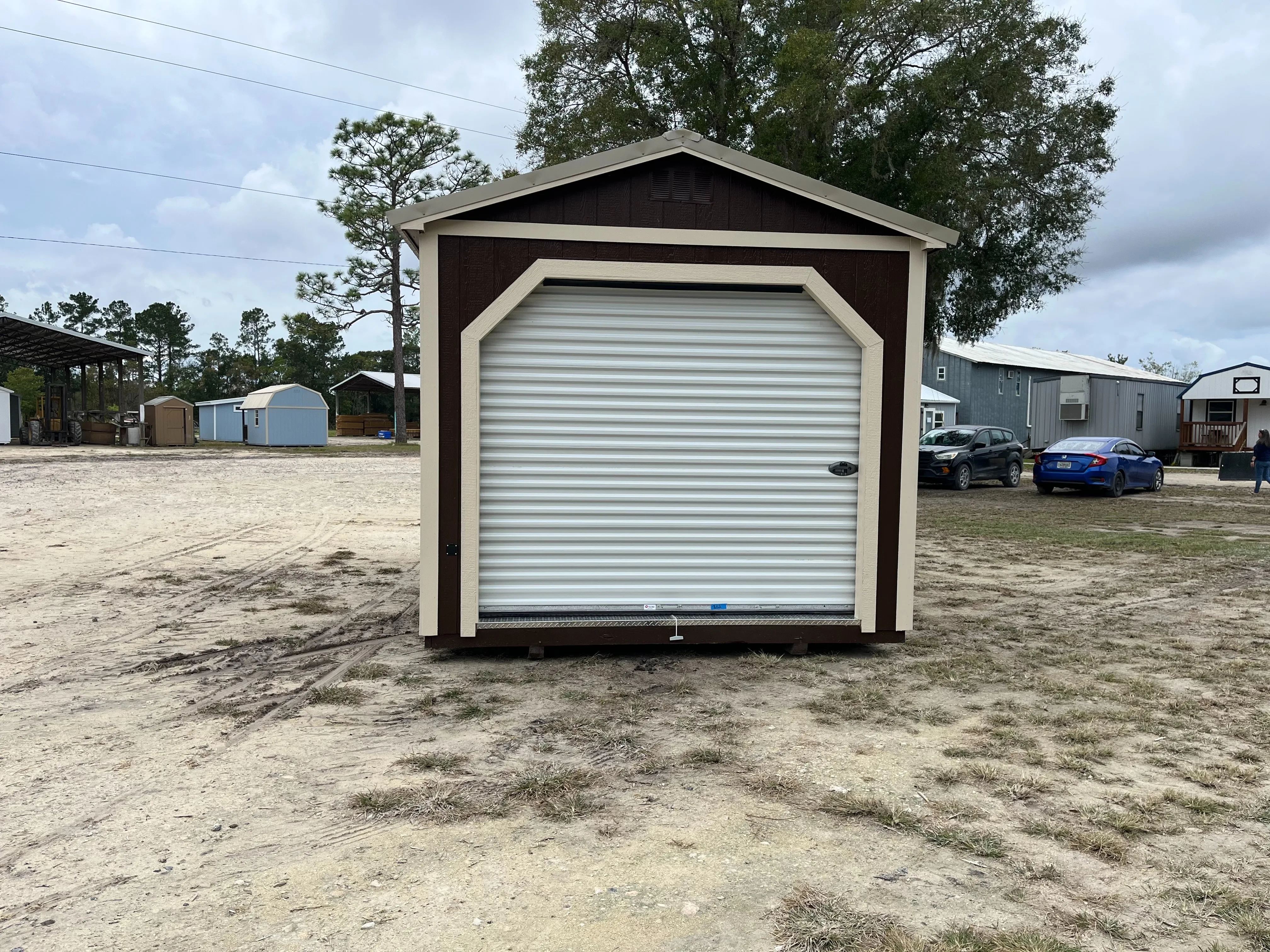 Exterior front of a garden shed with a roll up door