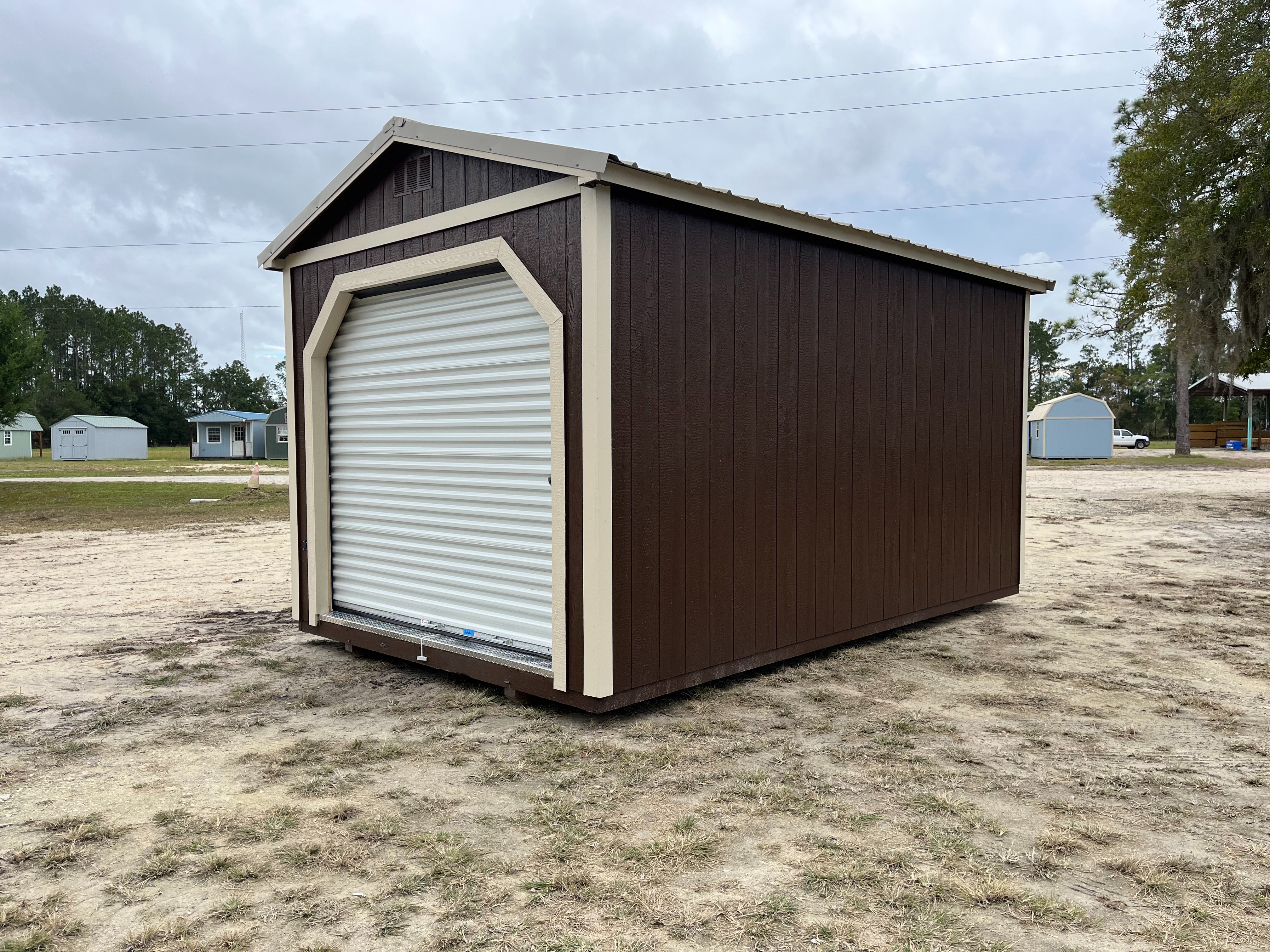 Exterior Right side of a10x16 garden shed with a roll up door