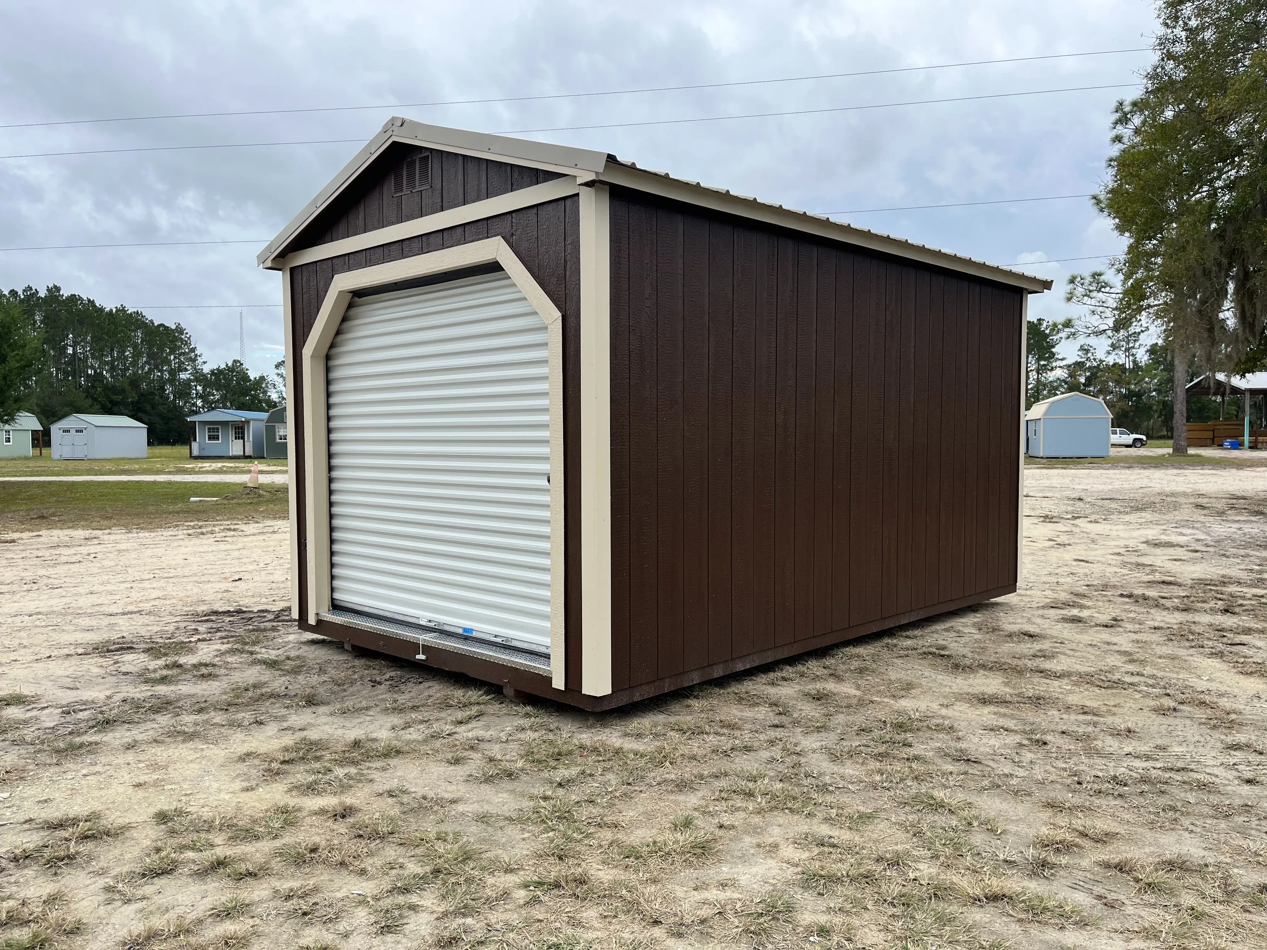 Exterior Right side of a10x16 garden shed with a roll up door