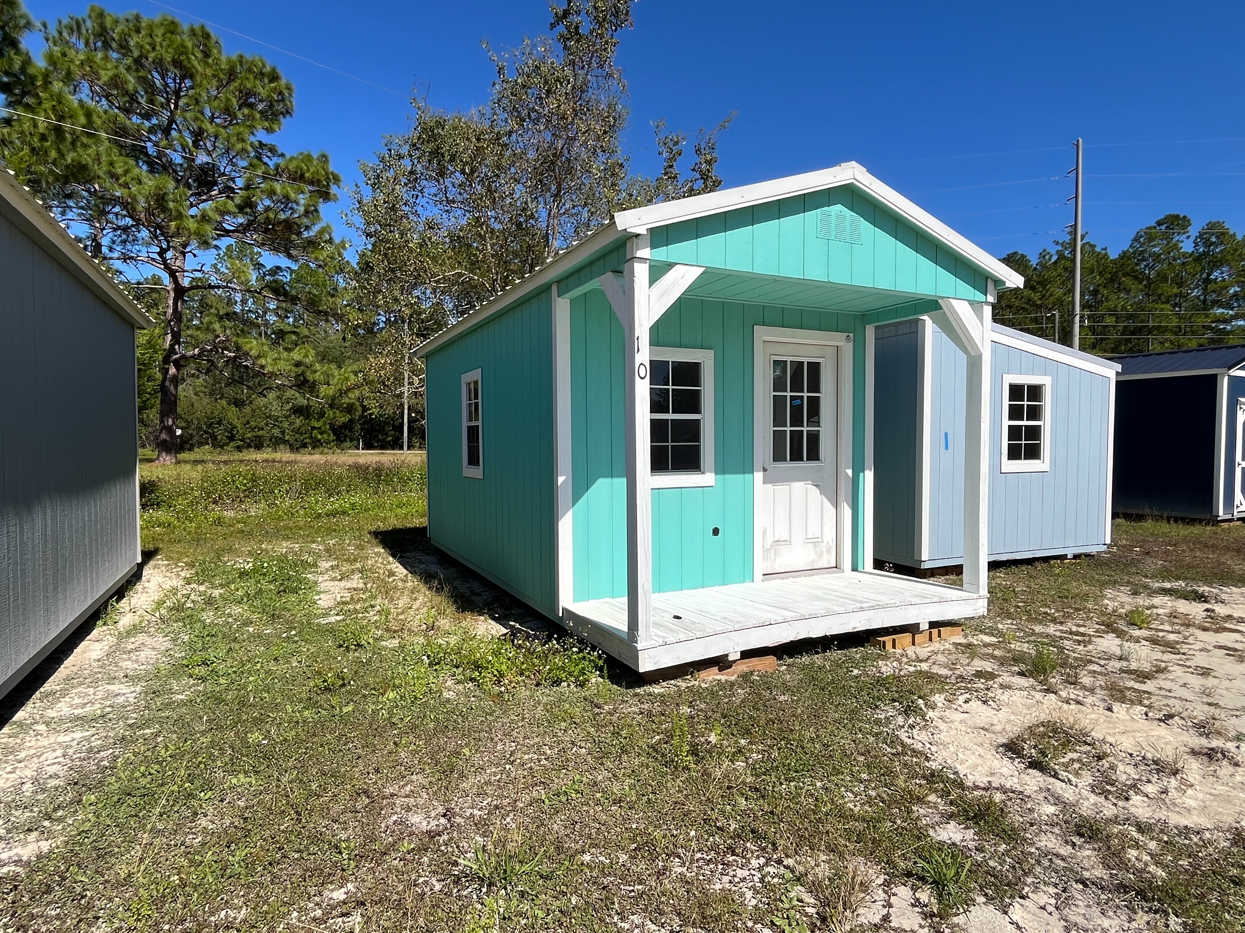 Exterior of a 10x20 Cabin showing the porch,  walk-in door and windows