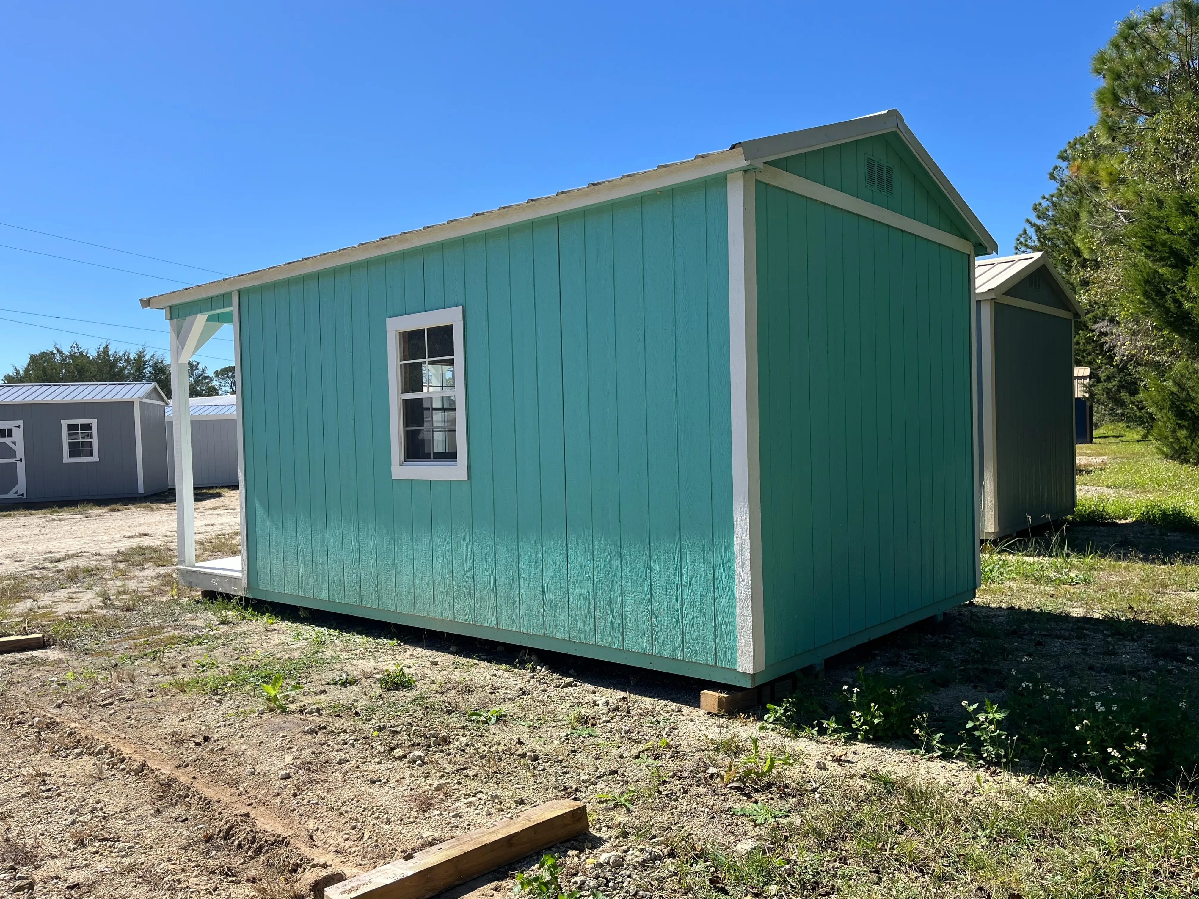 Exterior of a 10x20 Cabin showing the right side with window and rear of building