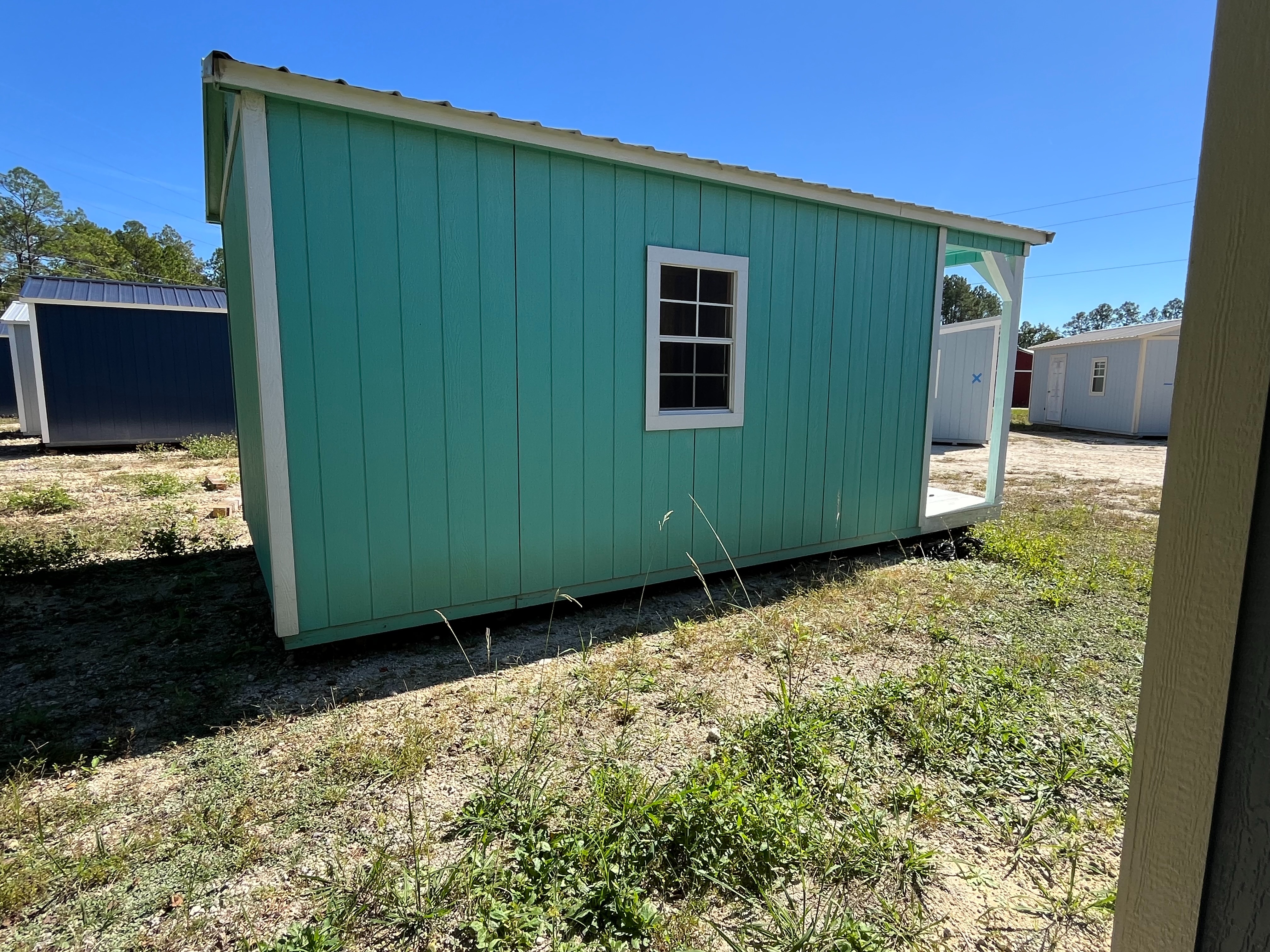 Exterior of a 10x20 Cabin showing the left side with window and rear of building