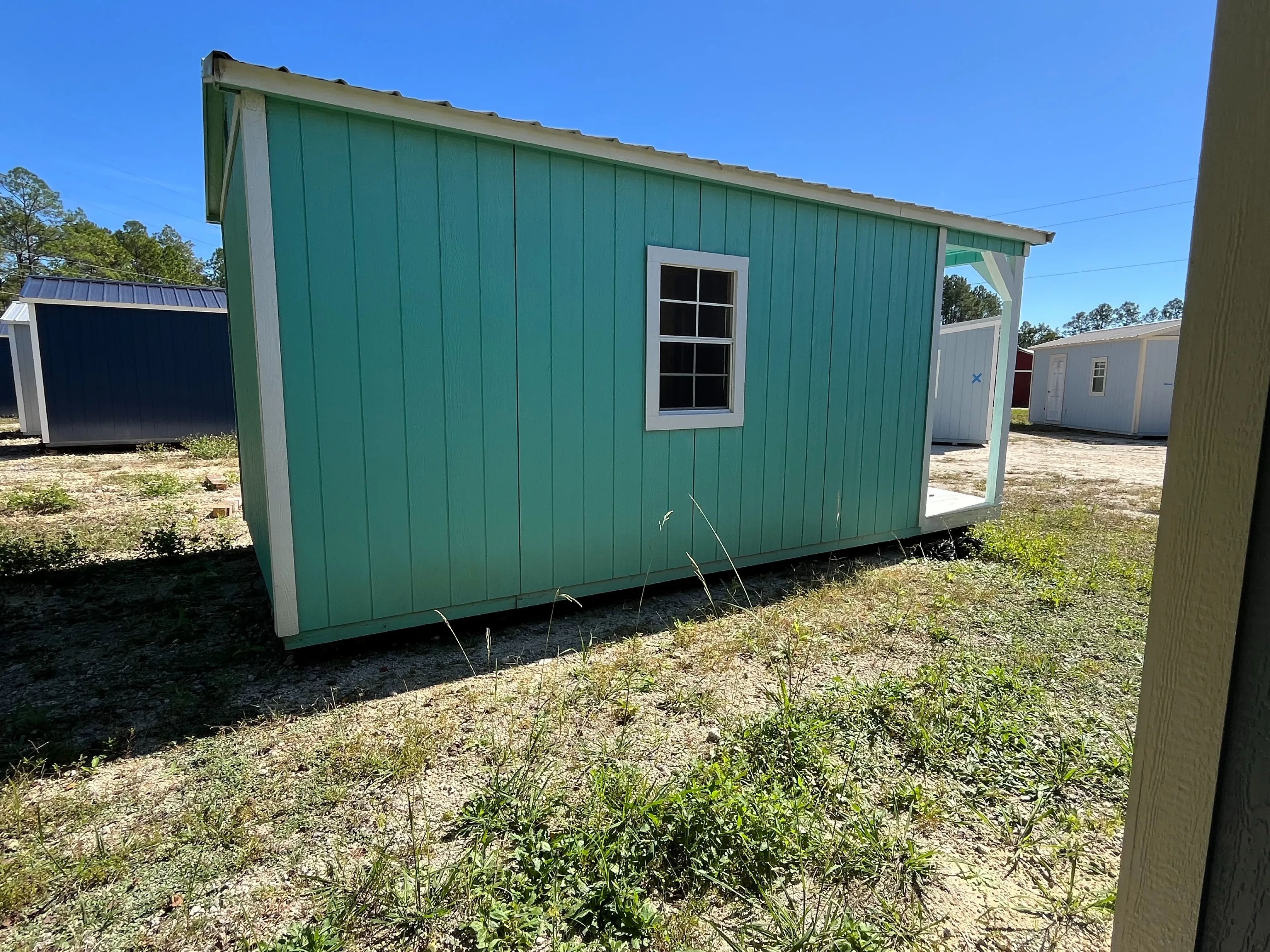 Exterior of a 10x20 Cabin showing the left side with window and rear of building