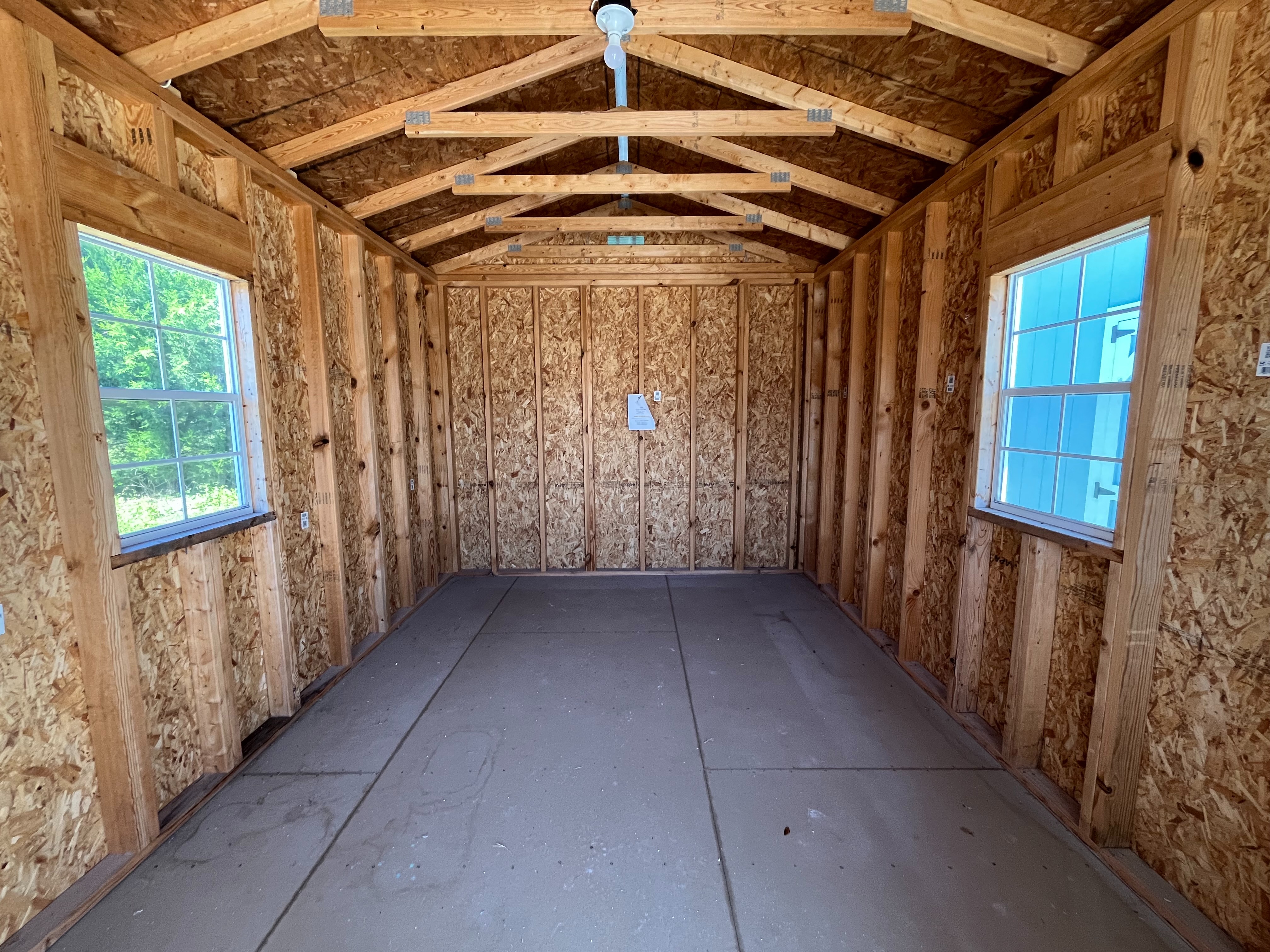 Interior of a 10x20 cabin through the walk-in door showing windows and electric