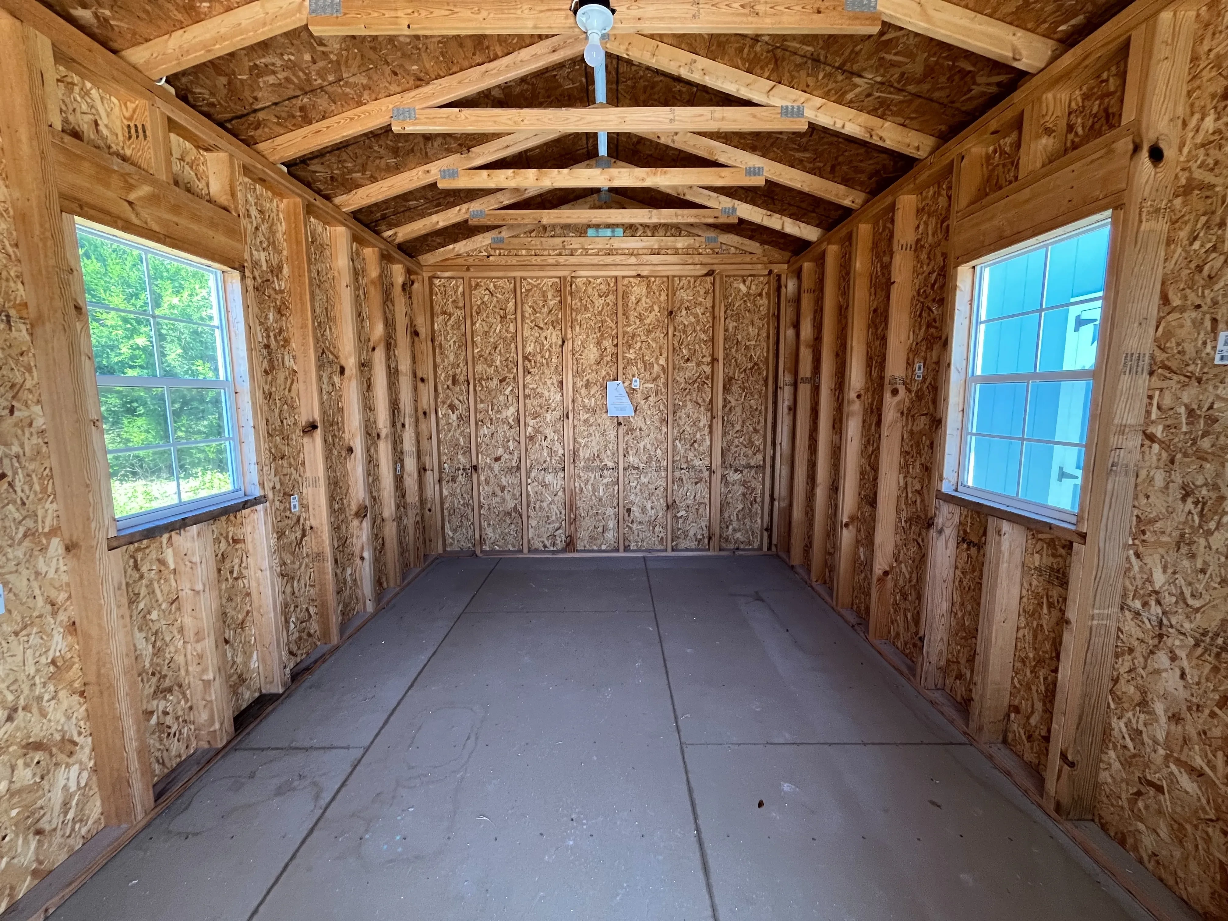 Interior of a 10x20 cabin through the walk-in door showing windows and electric