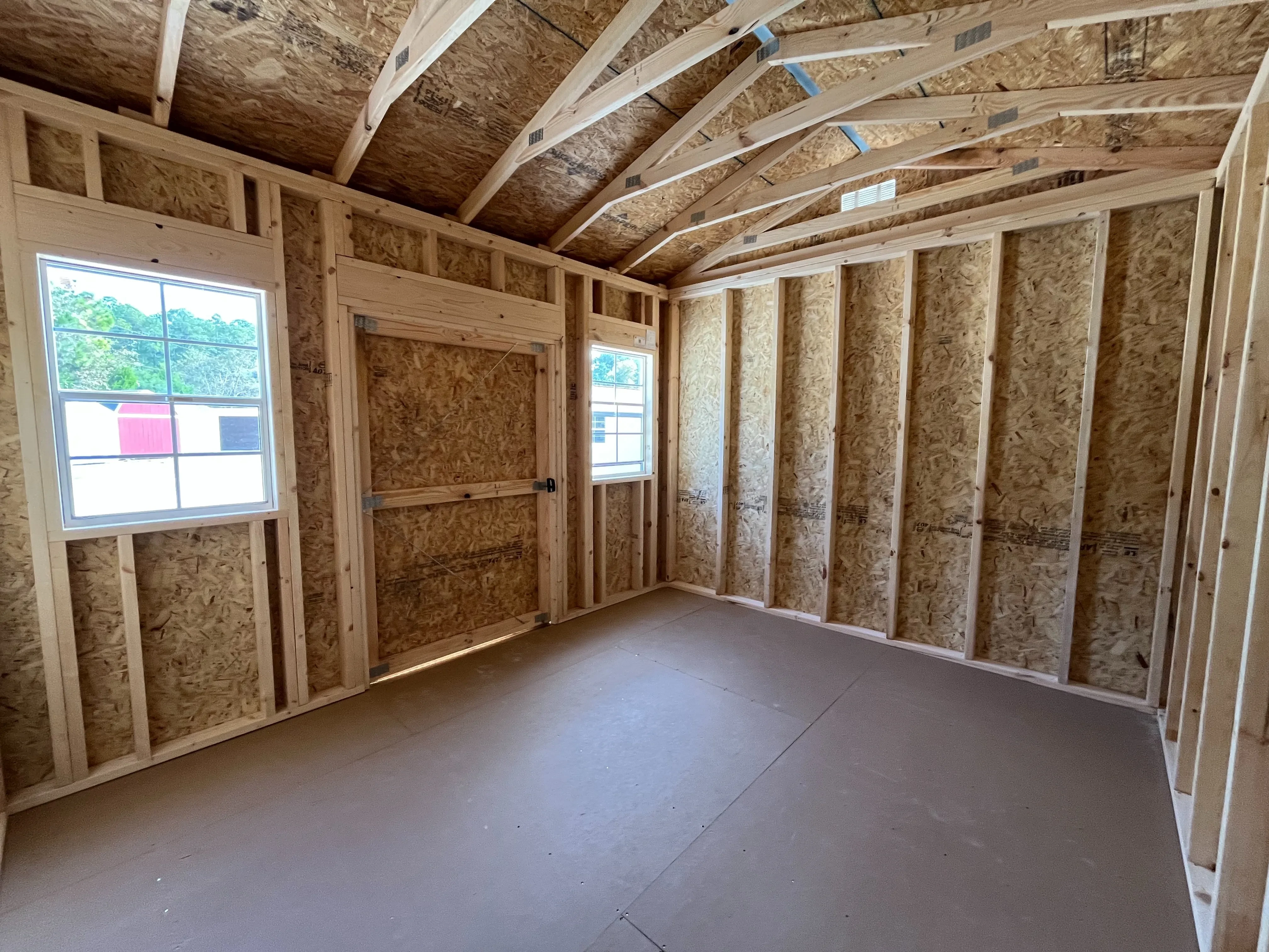 Interior photo of a 10x12 side garden shed showing the window and door
