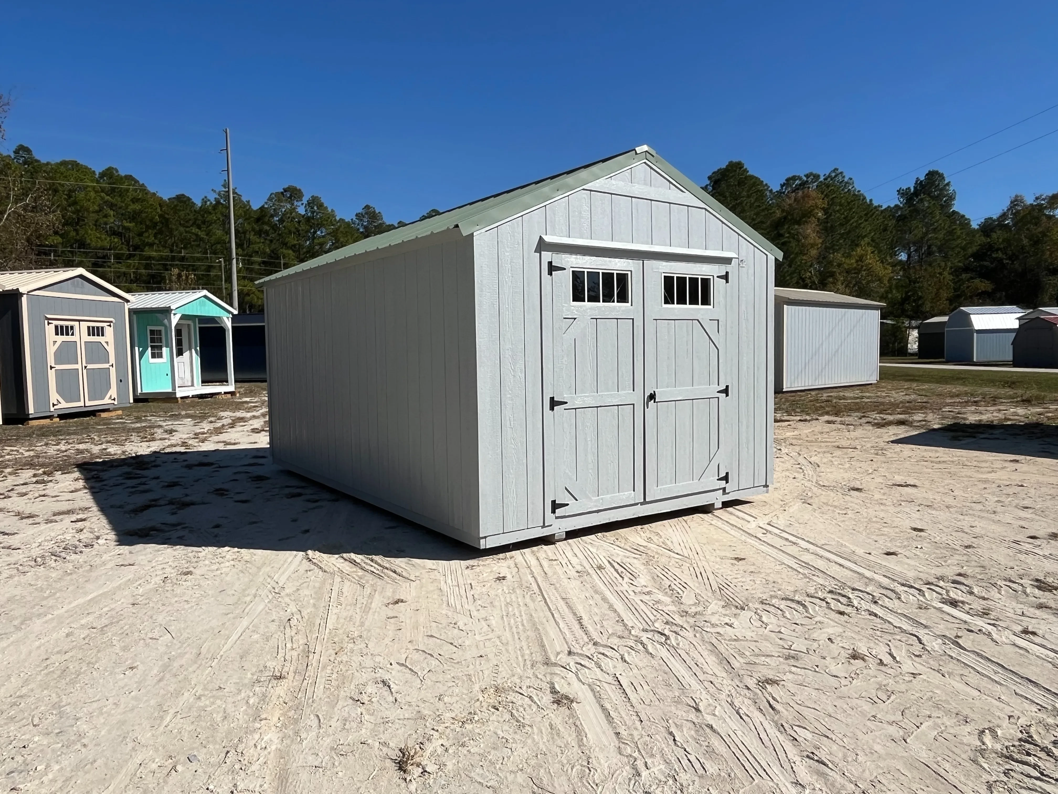 Front left Exterior of a dark grey 10x16 Garden Shed Economy with double wood doors with windows