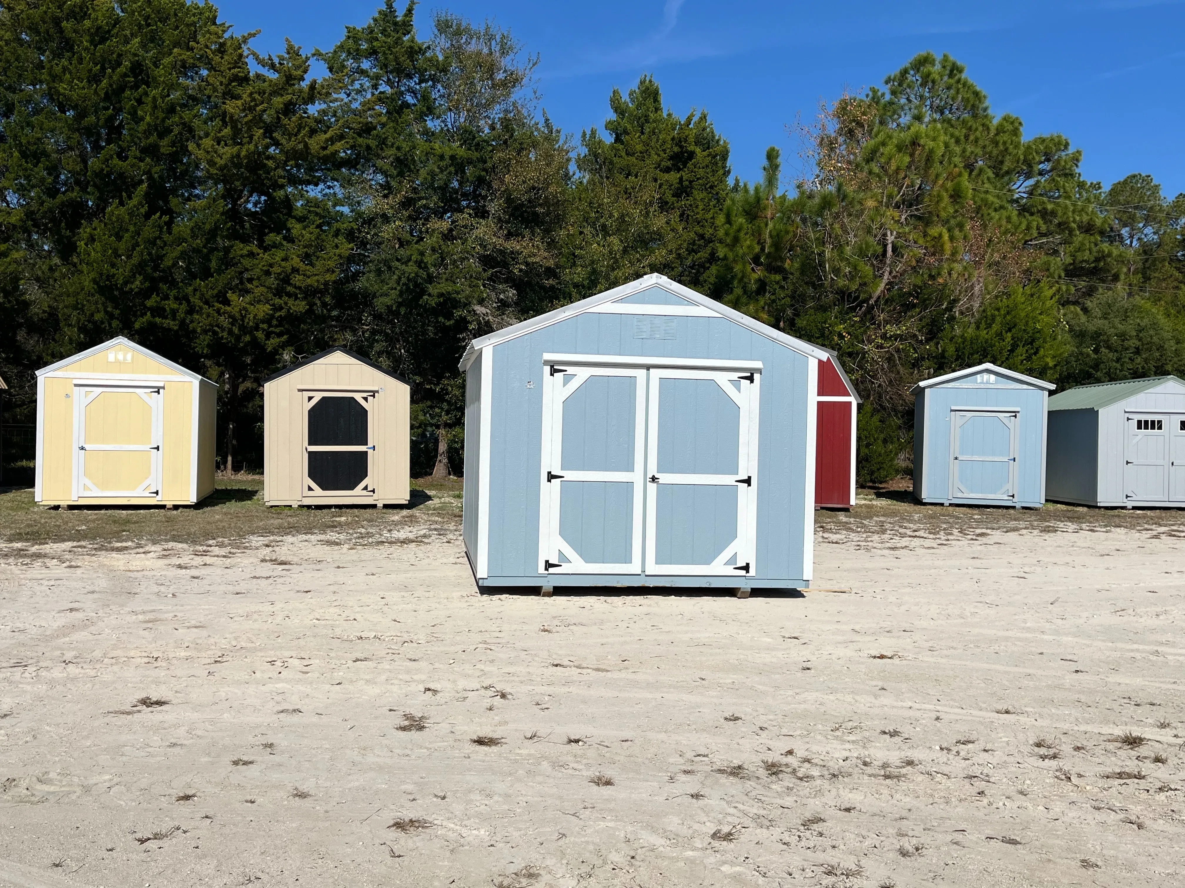 Exterior of a light blue 10x12 Garden Shed Economy with double wood doors