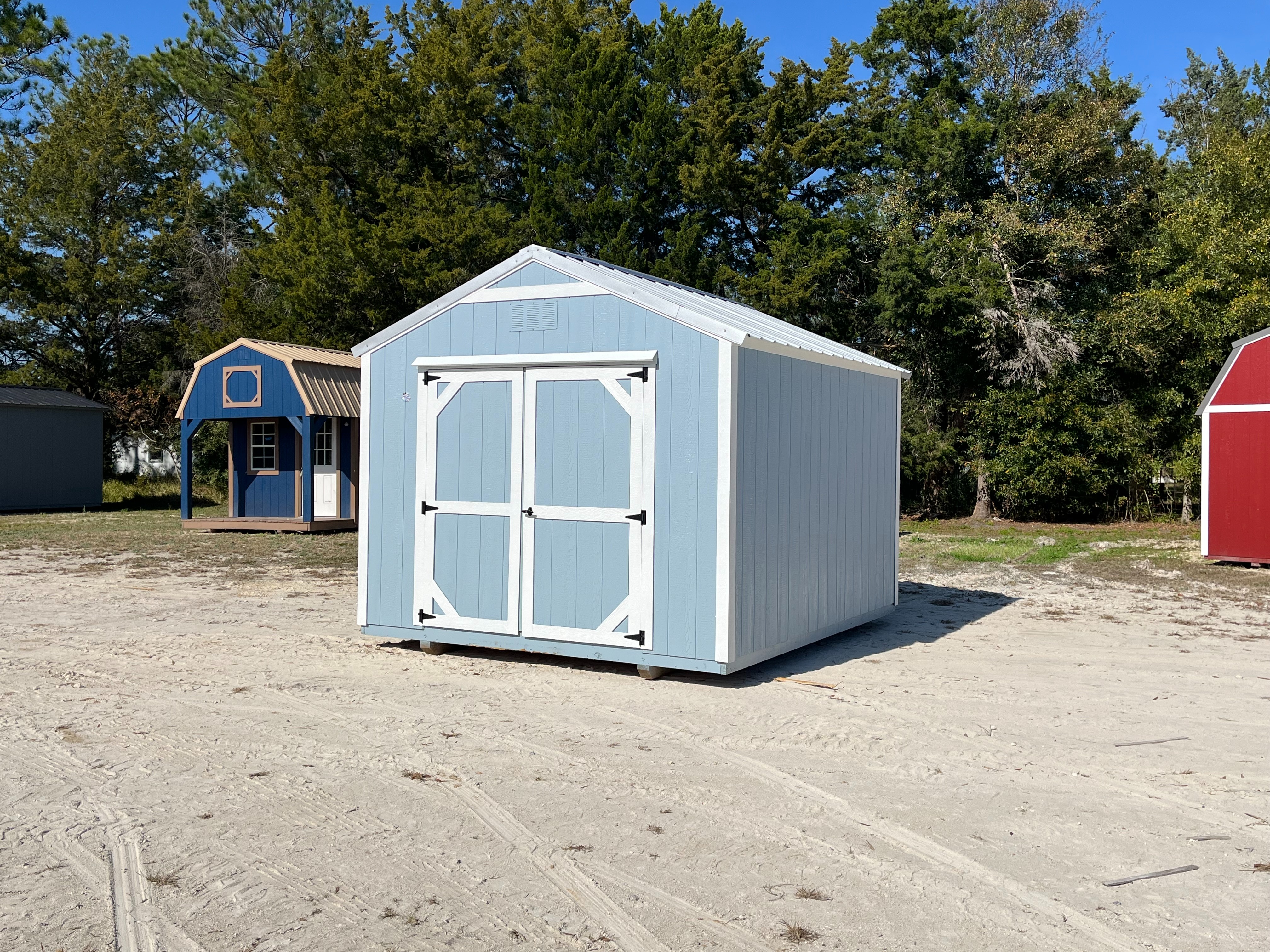 Exterior left side of a light blue 10x12 Garden Shed Economy with double wood doors