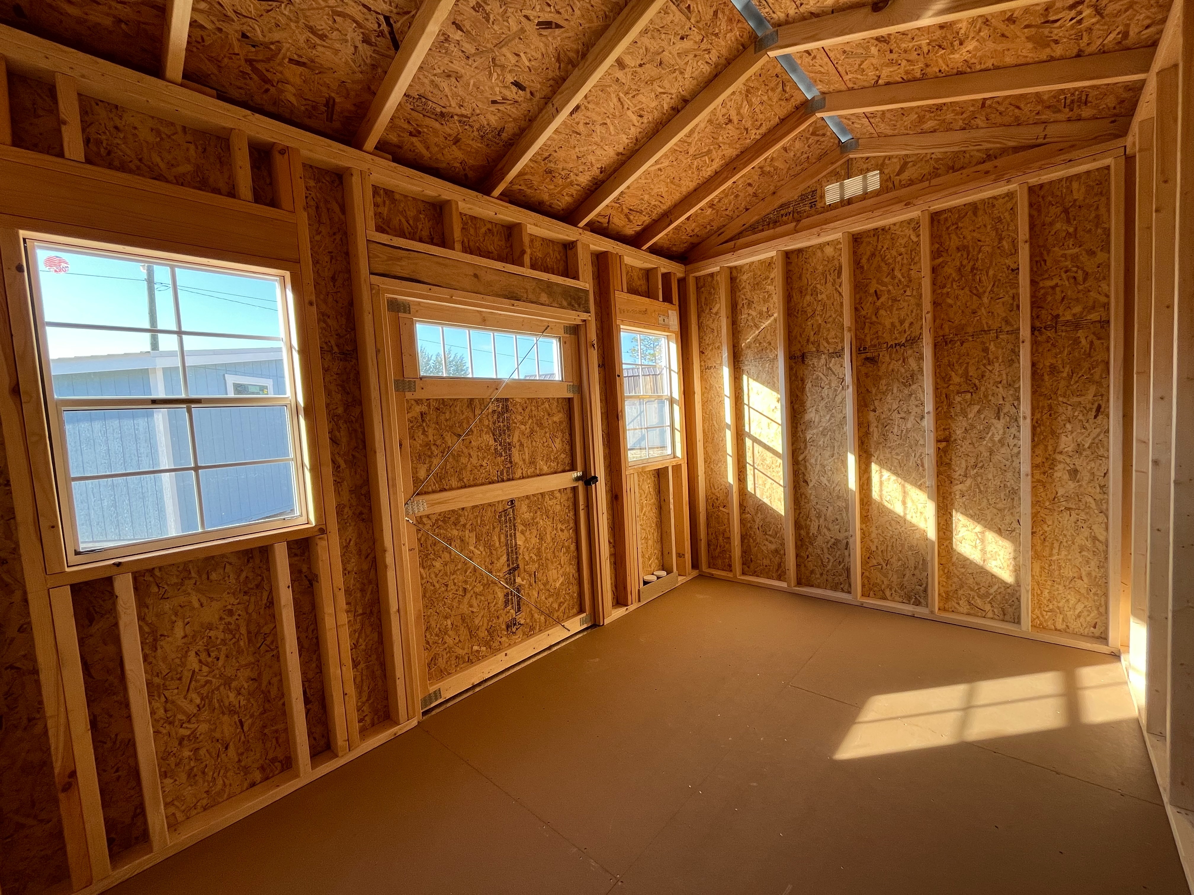 Interior view of an 8x12 side garden shed showing door and windows