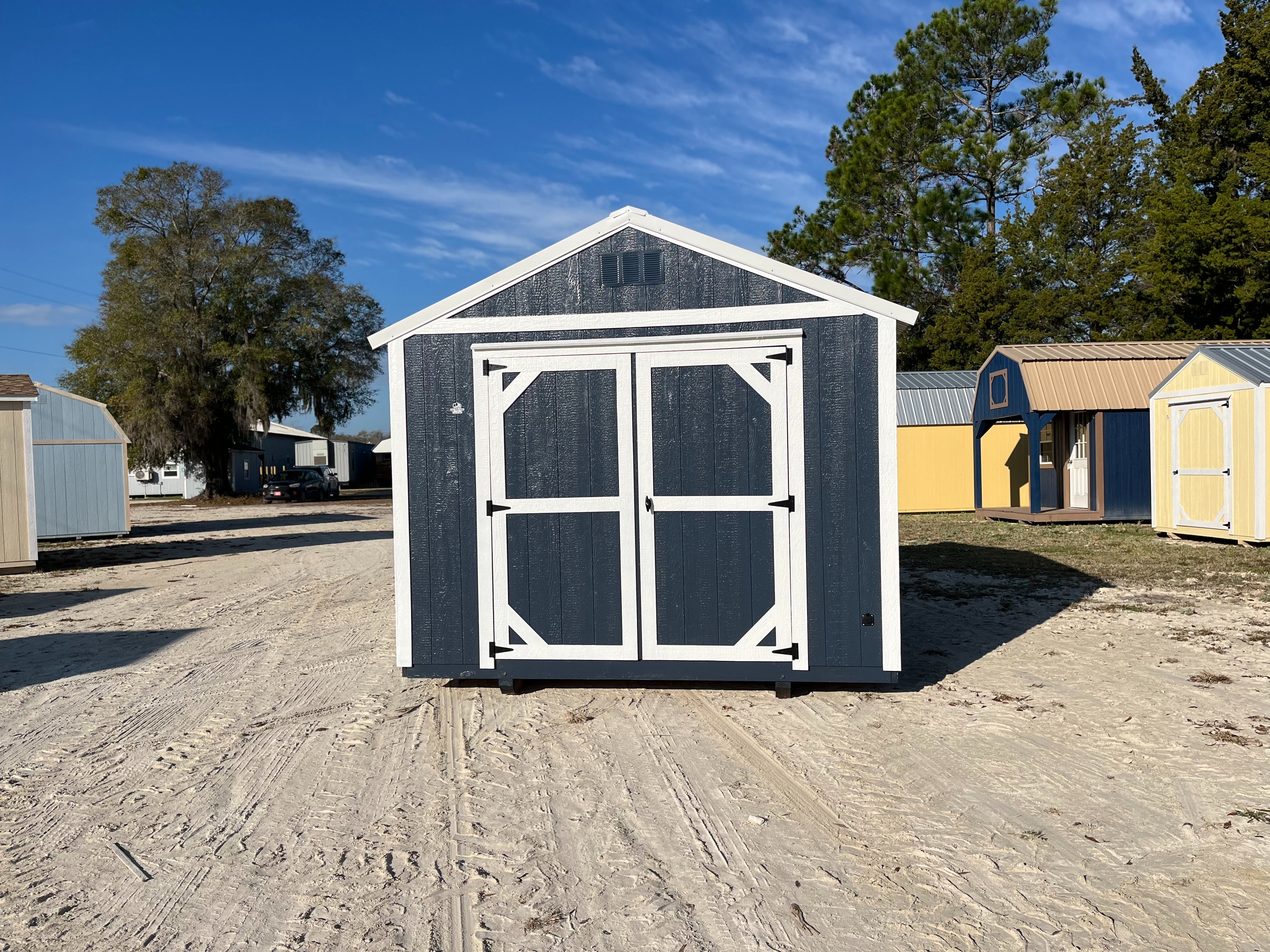 Exterior front view of a blue 10x12 garden shed economy with double wood doors